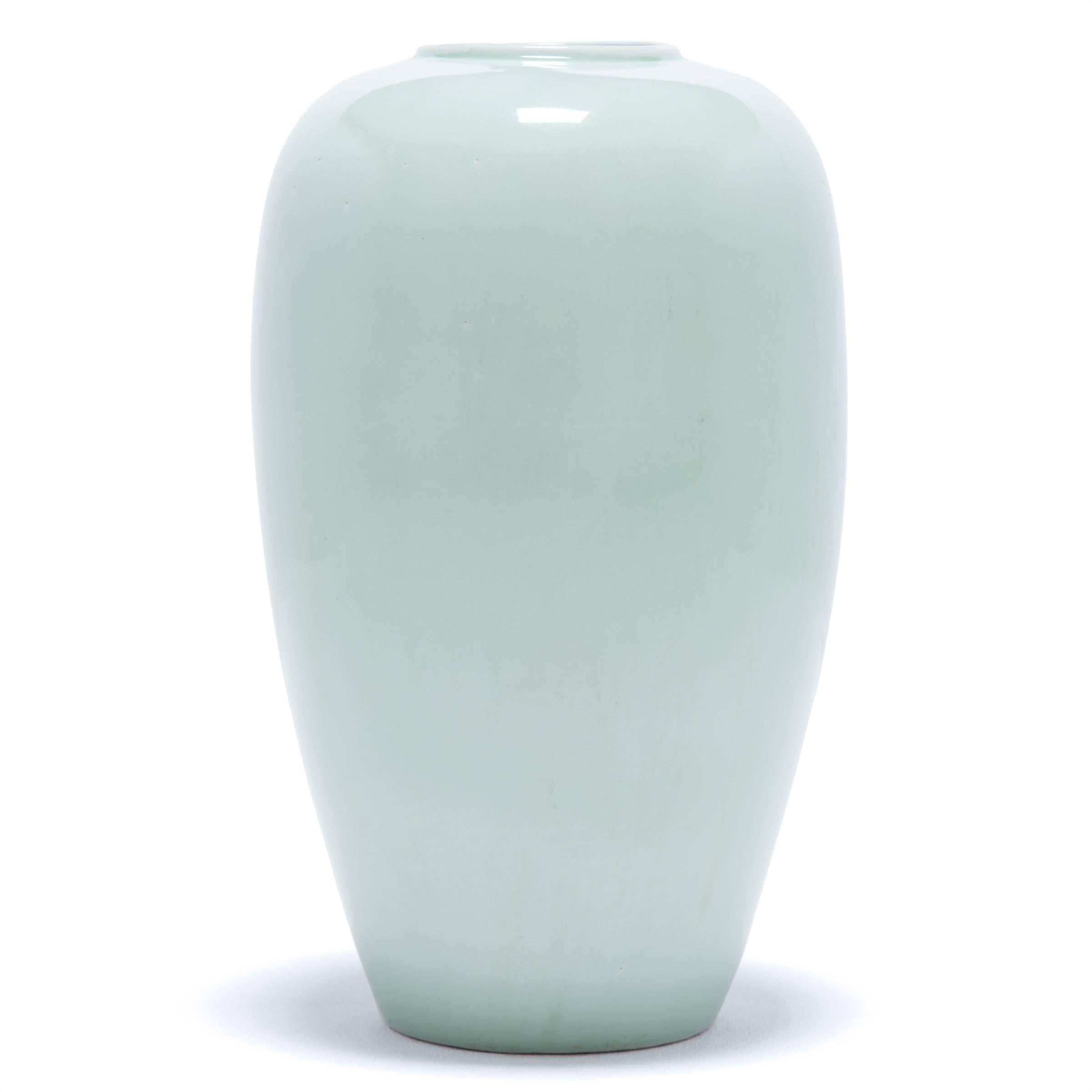 This sleek update on a traditional Chinese design displays an elegant, simplified Silhouette. Handcrafted in Zhejiang province, this contemporary vase showcases its Minimalist form with a gentle celadon glaze the color of creamy jade.

 