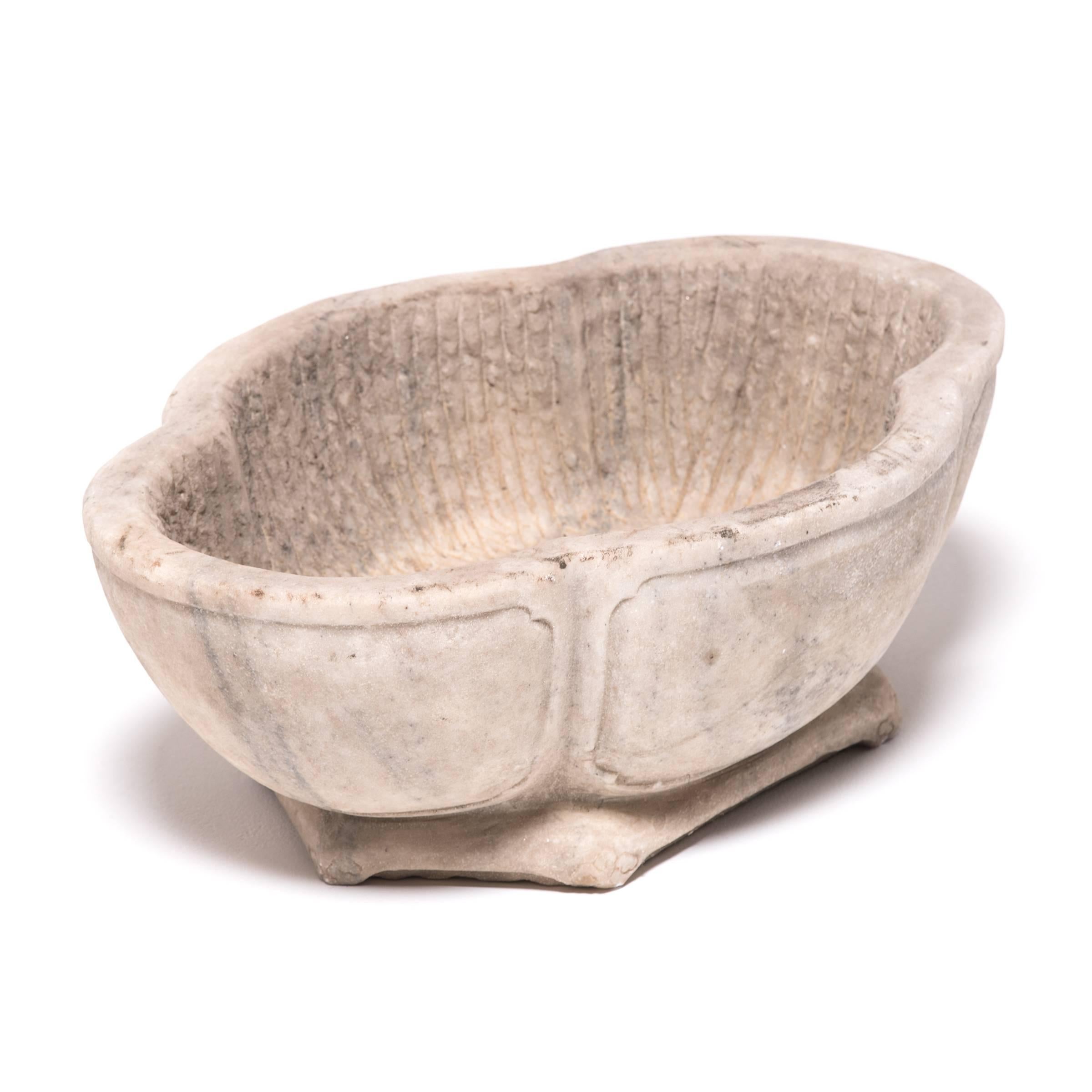 Shaped in a quatrefoil shape similar to that of a clove bud or common clover, this grey marble basin from Shanxi province has a graceful, low profile. Also suggestive of lotus blossom, a Buddhist symbol for purity, the shape of the basin feels right