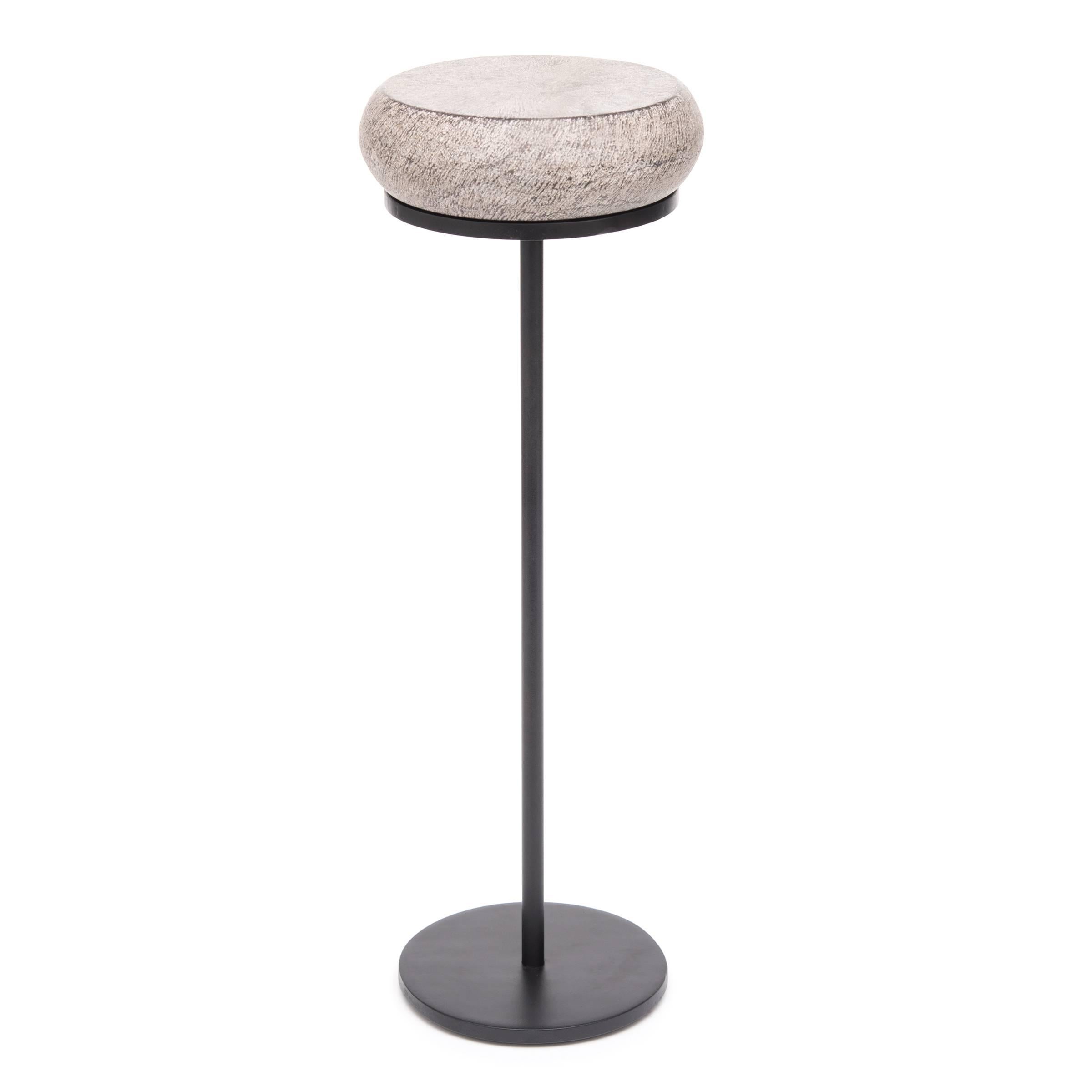 Traditional Chinese stone furniture-makers frequently mimicked drums in their carving forms. The shape featured in this petite drum table references a traditional hand held fish drum. In Taoist mythology the fish drum was the symbol of Zhang Guolao,