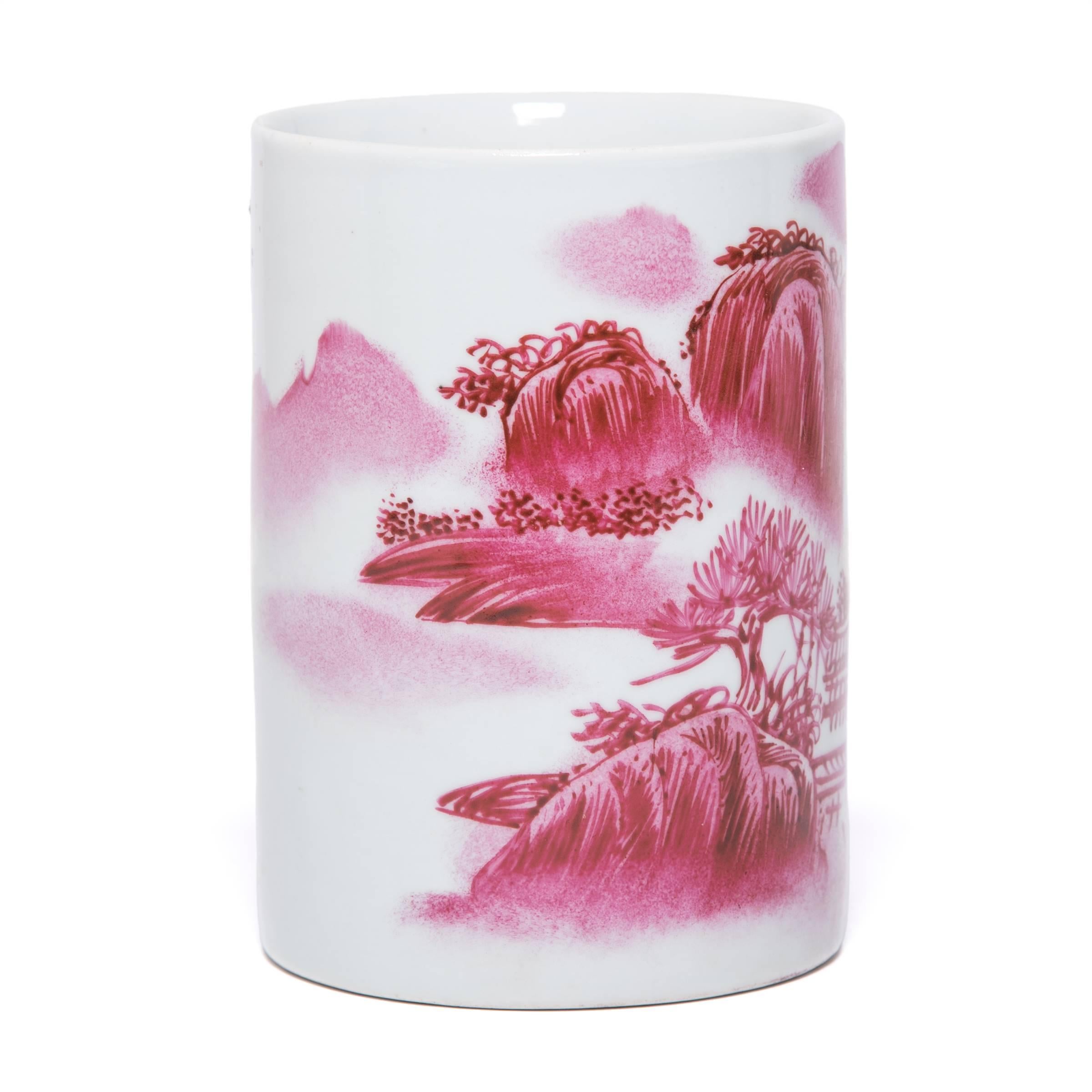 A twist on traditional blue-and-white ceramics, rich shades of red decorate this ceramic brush pot with a landscape rendered in the traditional shan shui painting style. Characterized by soft, feathery brushstrokes, the style advocates balance,