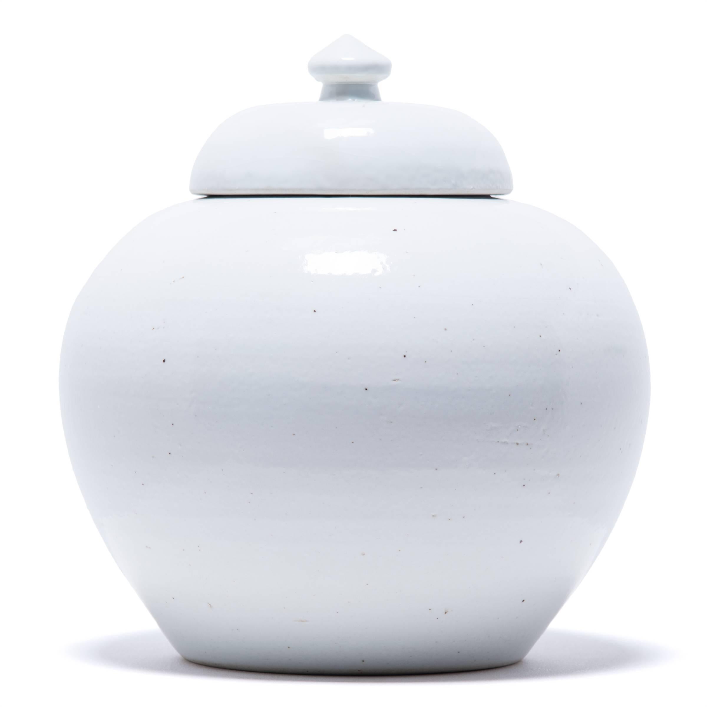The hand-applied milky glaze on this stoneware container emphasizes the sculptural form of this contemporary update on a Chinese Classic. Refining the traditional onion shape, the quiet monochrome plays beautifully with its clean lines and