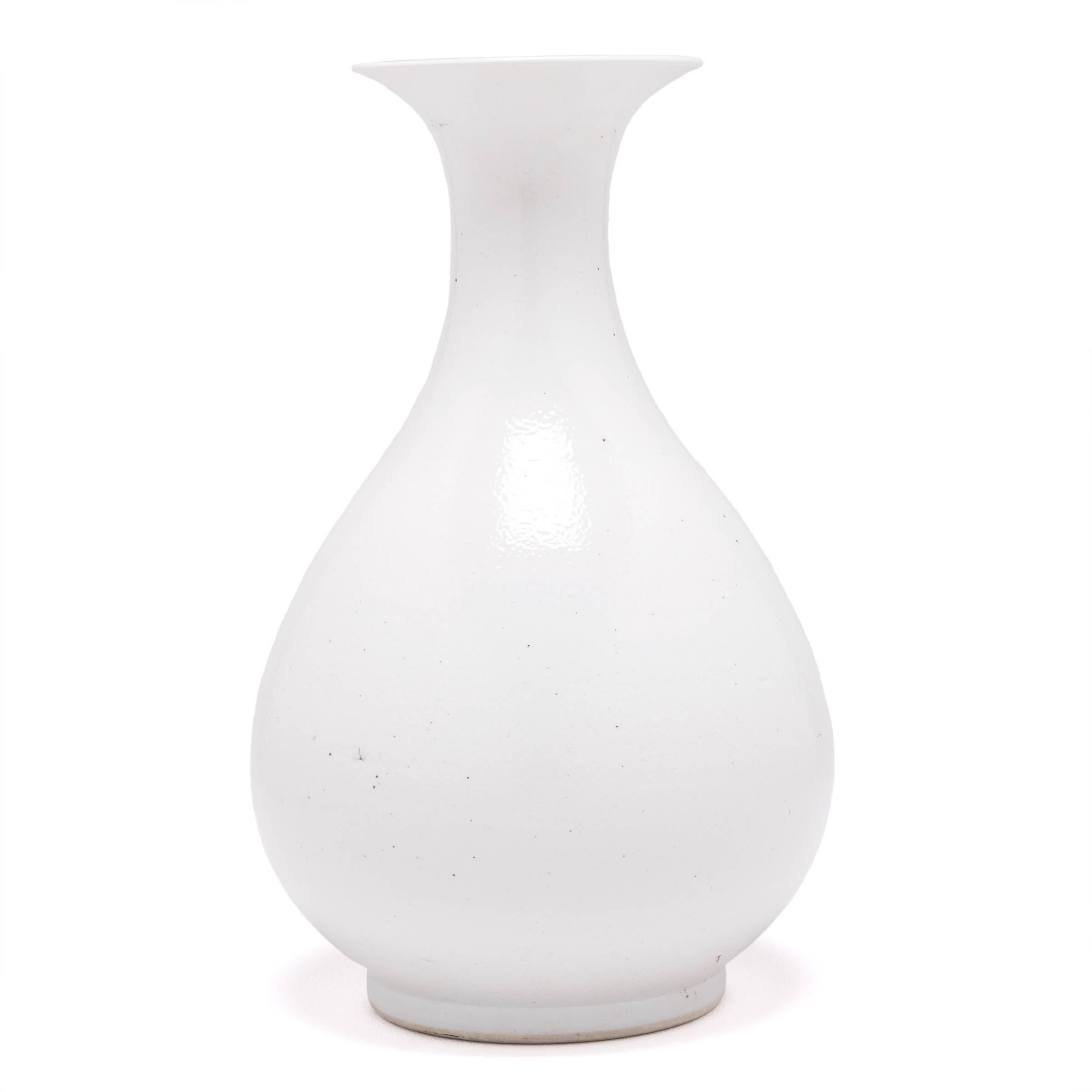Drawing on a long Chinese tradition of monochrome ceramics, this striking vase is glazed in statement-making white. Inspired by a bird’s fanned out tail, this contemporary example reinterprets this traditional shape with clean lines and an
