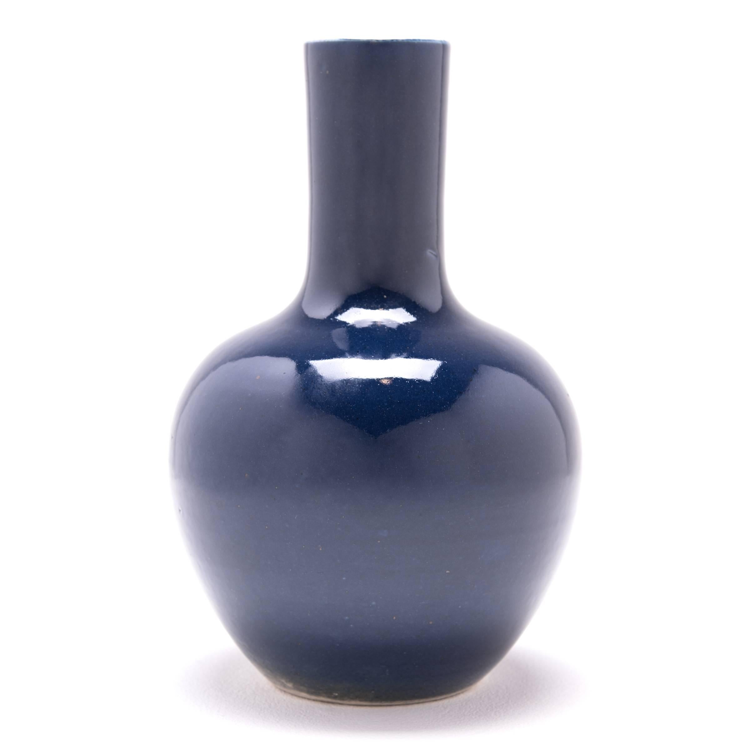 This modern gooseneck vase was made by a skilled artisan, knowledgeable in the ancient techniques of glazing which made Chinese ceramics world renown. This distinctive color is known as indigo. Across Asia and Europe the color blue gained important