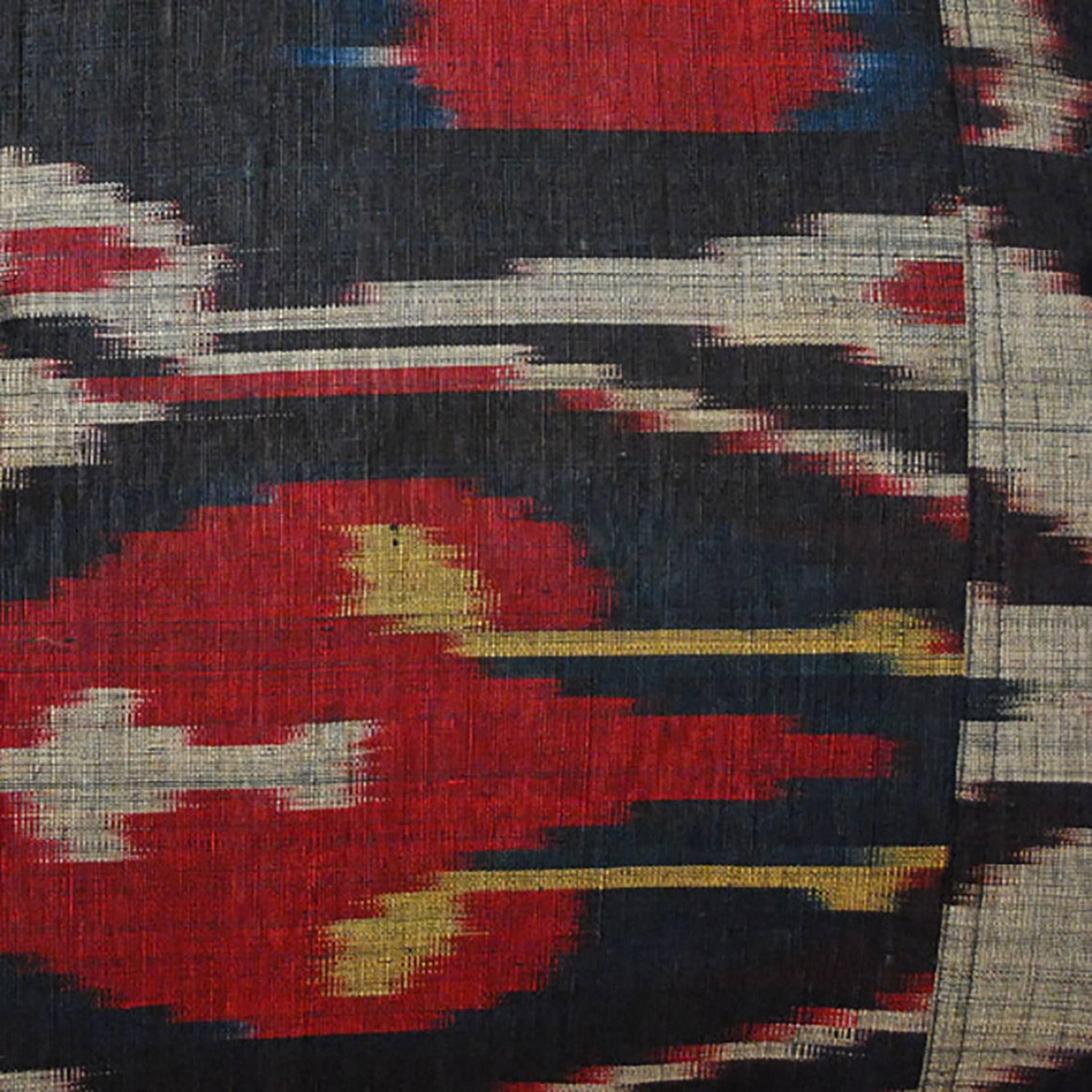 This artisan-designed pillow is made by hand of vintage Indonesian ikat fabric. Ikat is a dyeing technique used to pattern textiles that employs a resist dyeing process. The resist is formed by binding individual yarns or bundles of yarns with a