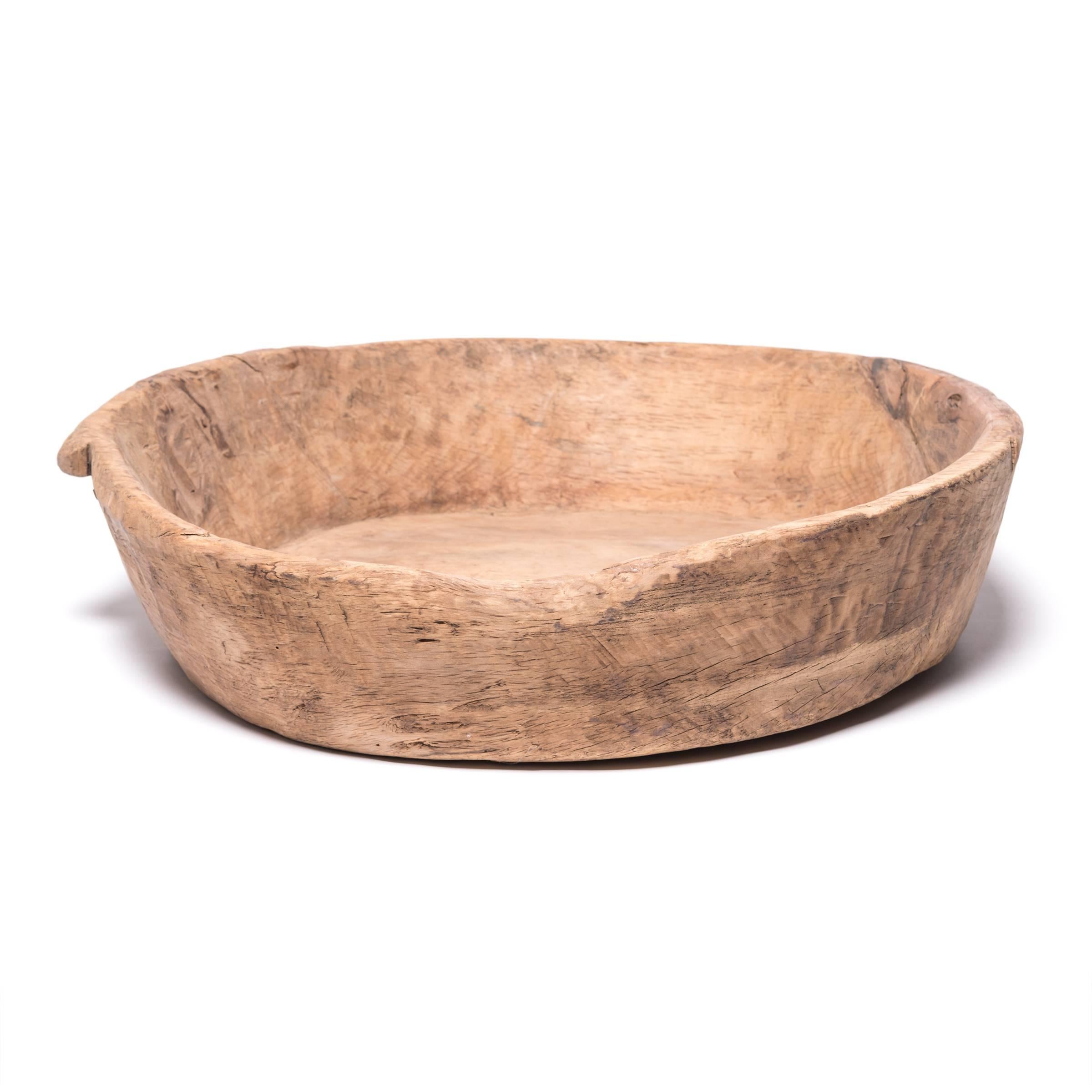 Originally crafted in Mongolia, this tray's imperfect round is a wabi-sabi reference to daily life in faraway pastures. Hand-carved from cypress, its soft nature has been enriched by over one hundred years of use. It is a warm welcome to modern