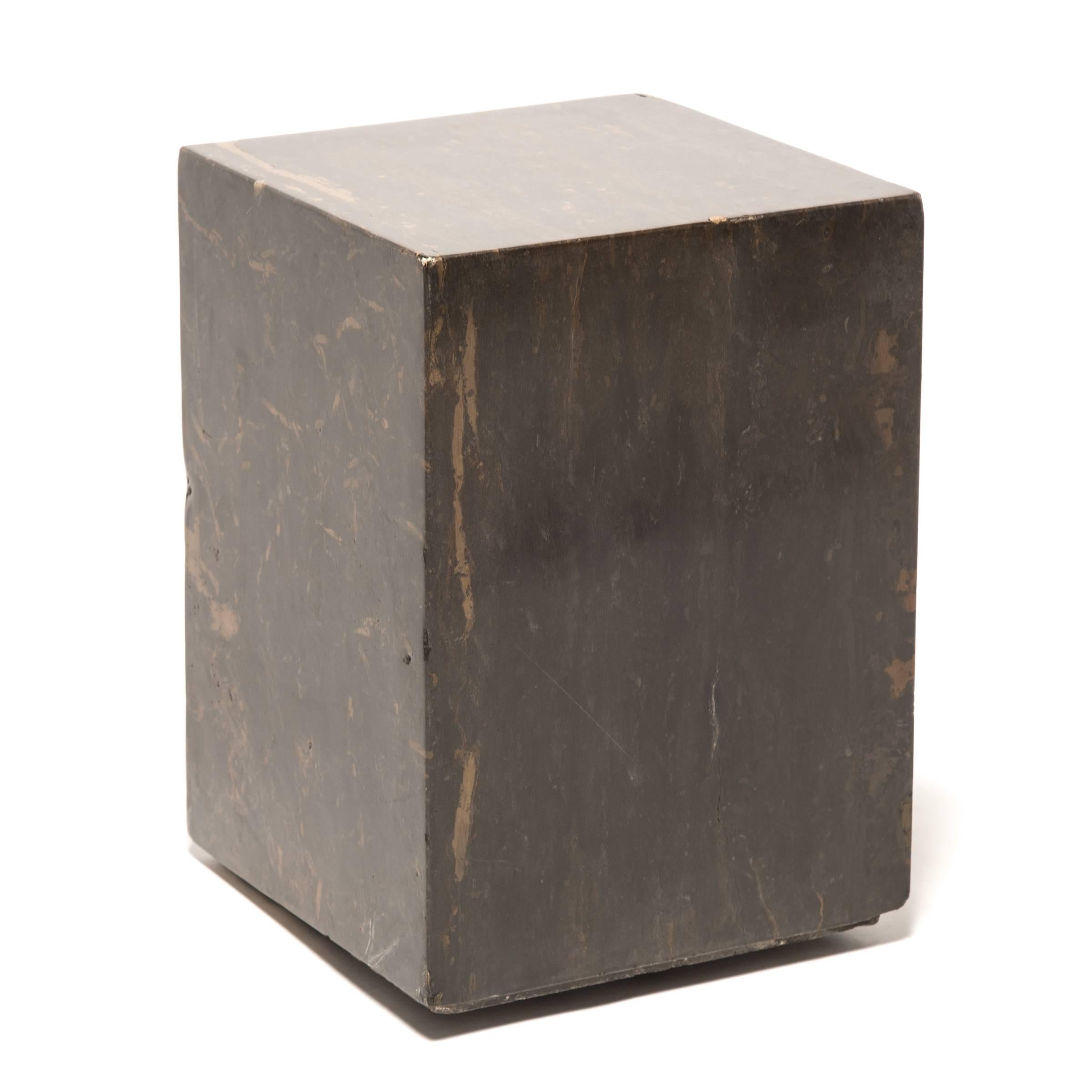 The design of these contemporary Doon tables makes the solid marble appear to float off the ground. Hand-carved perfectly into a marble block, the base has a graceful reveal, giving the stone a modern lightness. The table's rich bronze color is