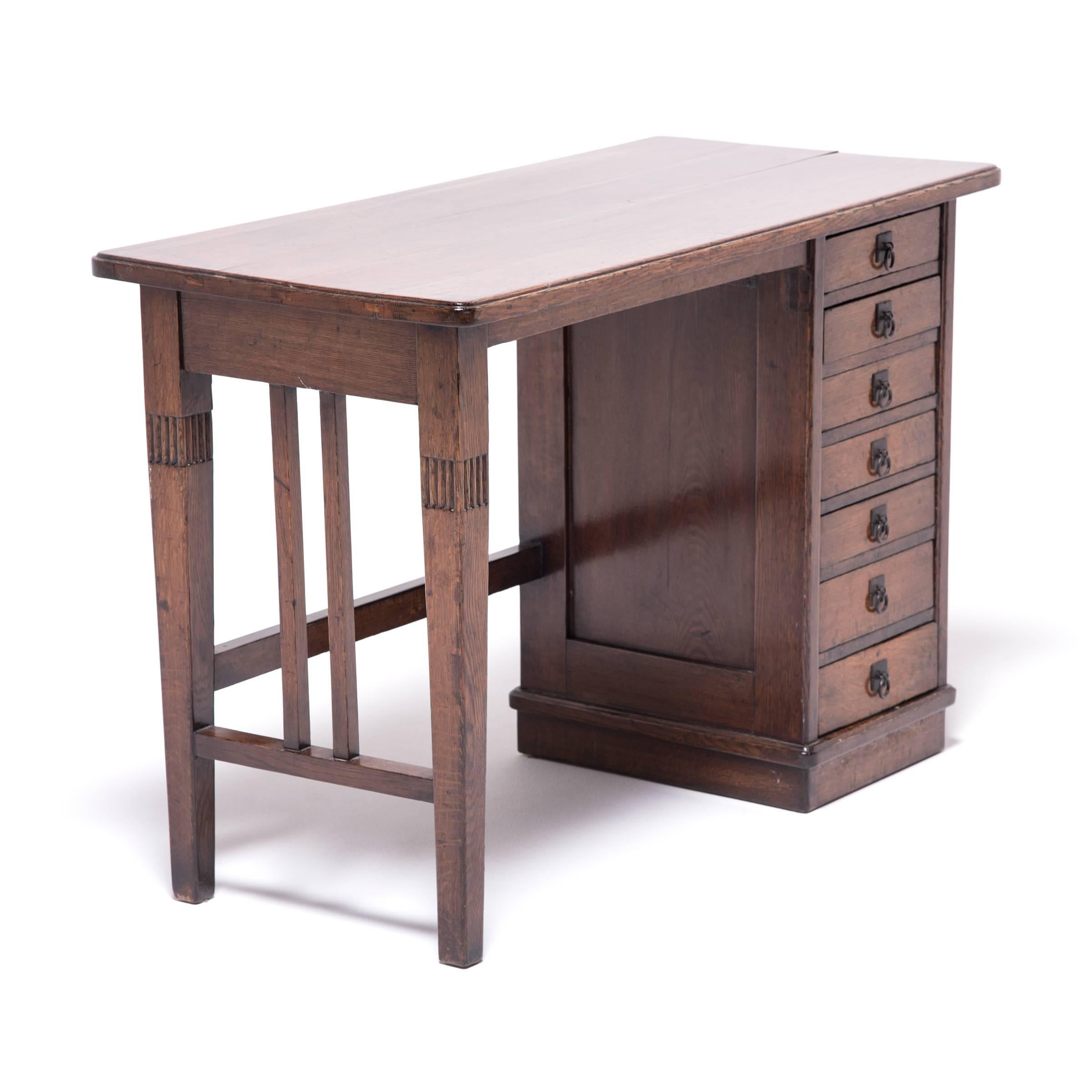 This petite elmwood desk charms with its unusual blend of east and west styles. Made in Northern China, the desk dates to the late 19th century, a period that saw great cultural exchange in art and design. Perhaps commissioned by a foreigner or