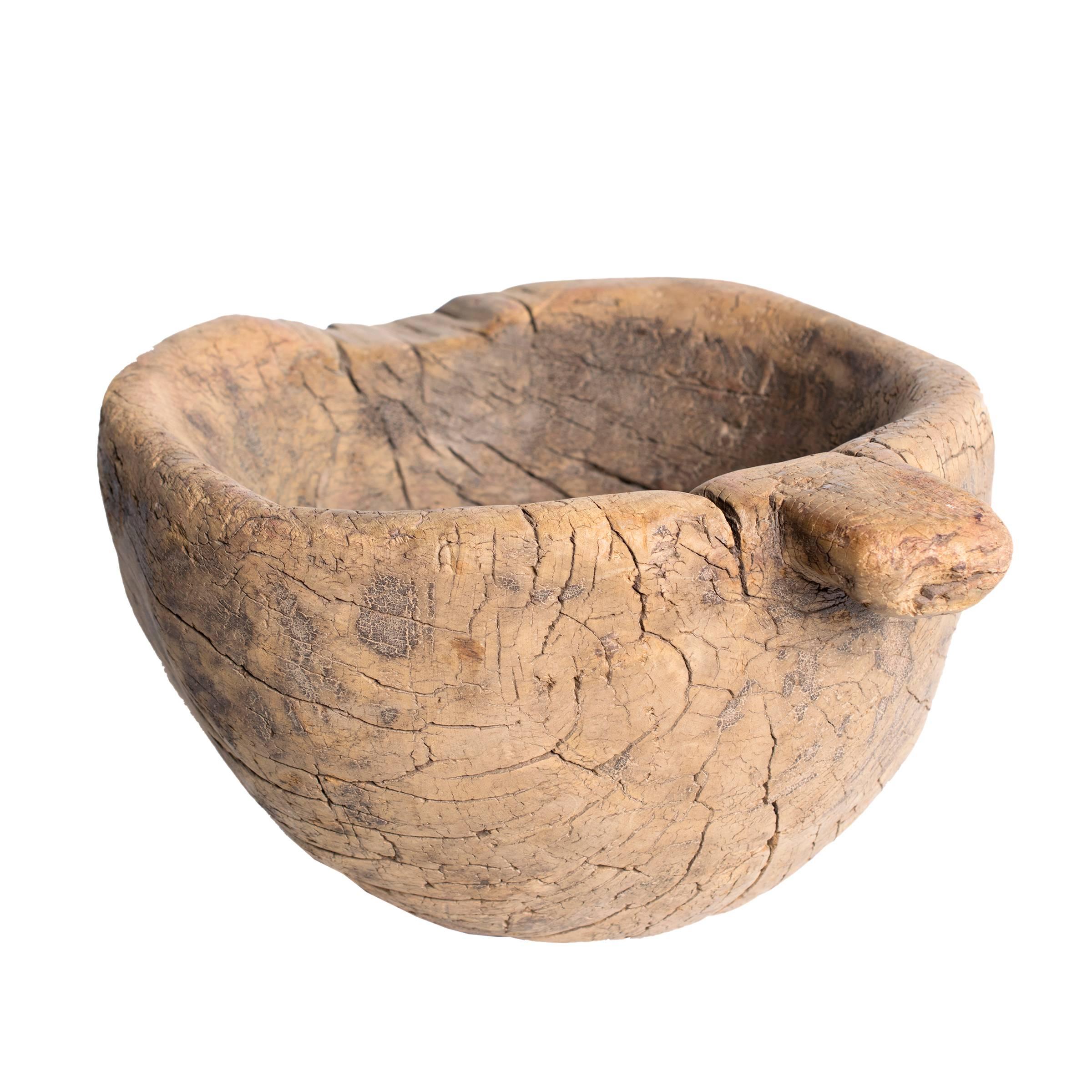 Used to grind the outer husks off rice grains, this humble 19th century mortar hales from northern China, where it had been a kitchen staple in a Provincial home. Carved from elmwood, the mortar’s simple, gourd-like shape transcends pure function to