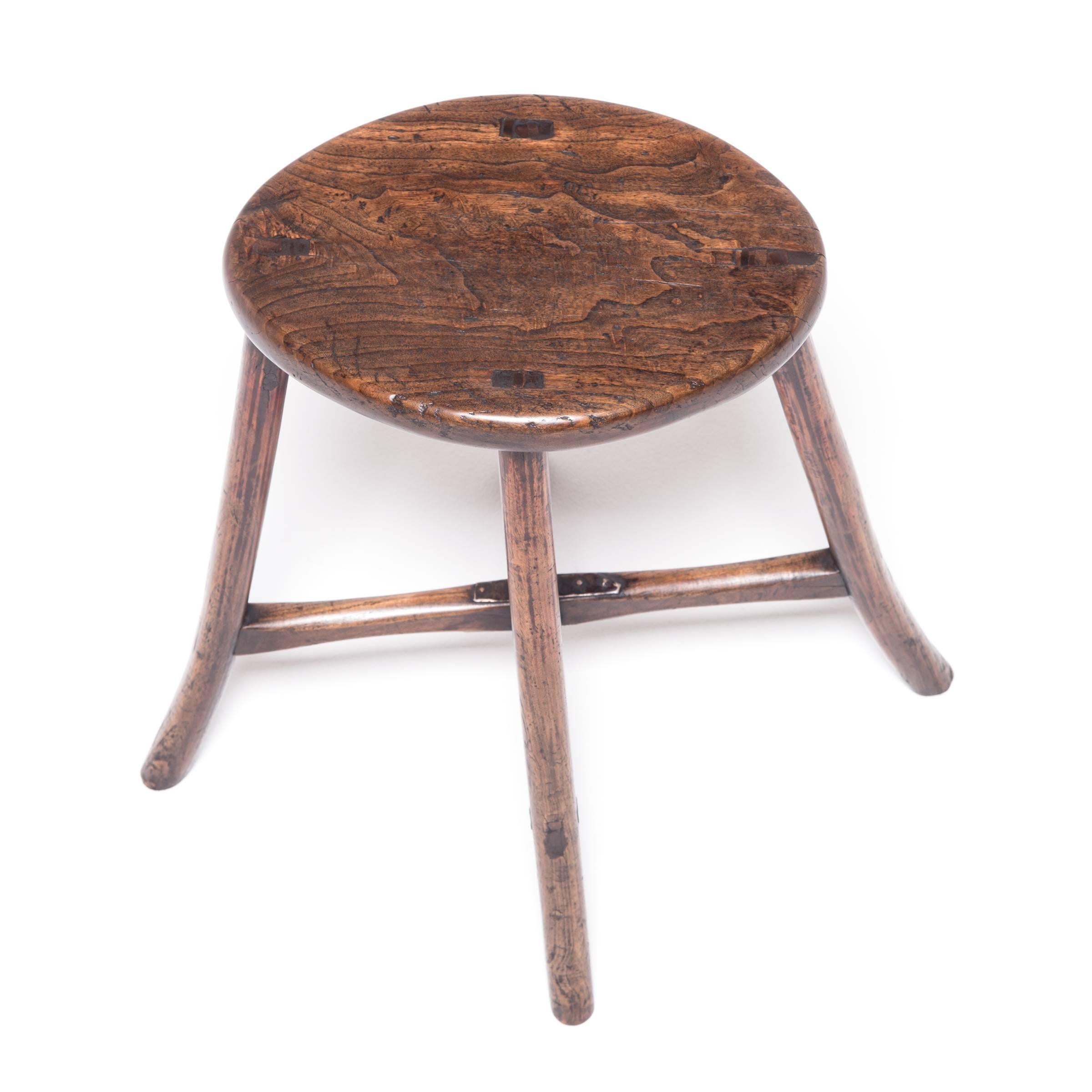 The traditional squared lines of Ming furniture are given a distinctive curved flair in this Provincial stool. The oval seat and slightly flared legs combine for a dynamic and fluid form. The wood has aged with rich character that adds great texture