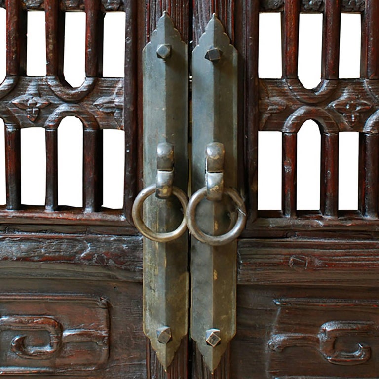 A hallmark of Qing-dynasty domestic architecture, hand-carved lattice panels such as these were used in courtyard homes to allow light and air into a room while maintaining privacy. This pair of 19th-century courtyard doors feature simply carved