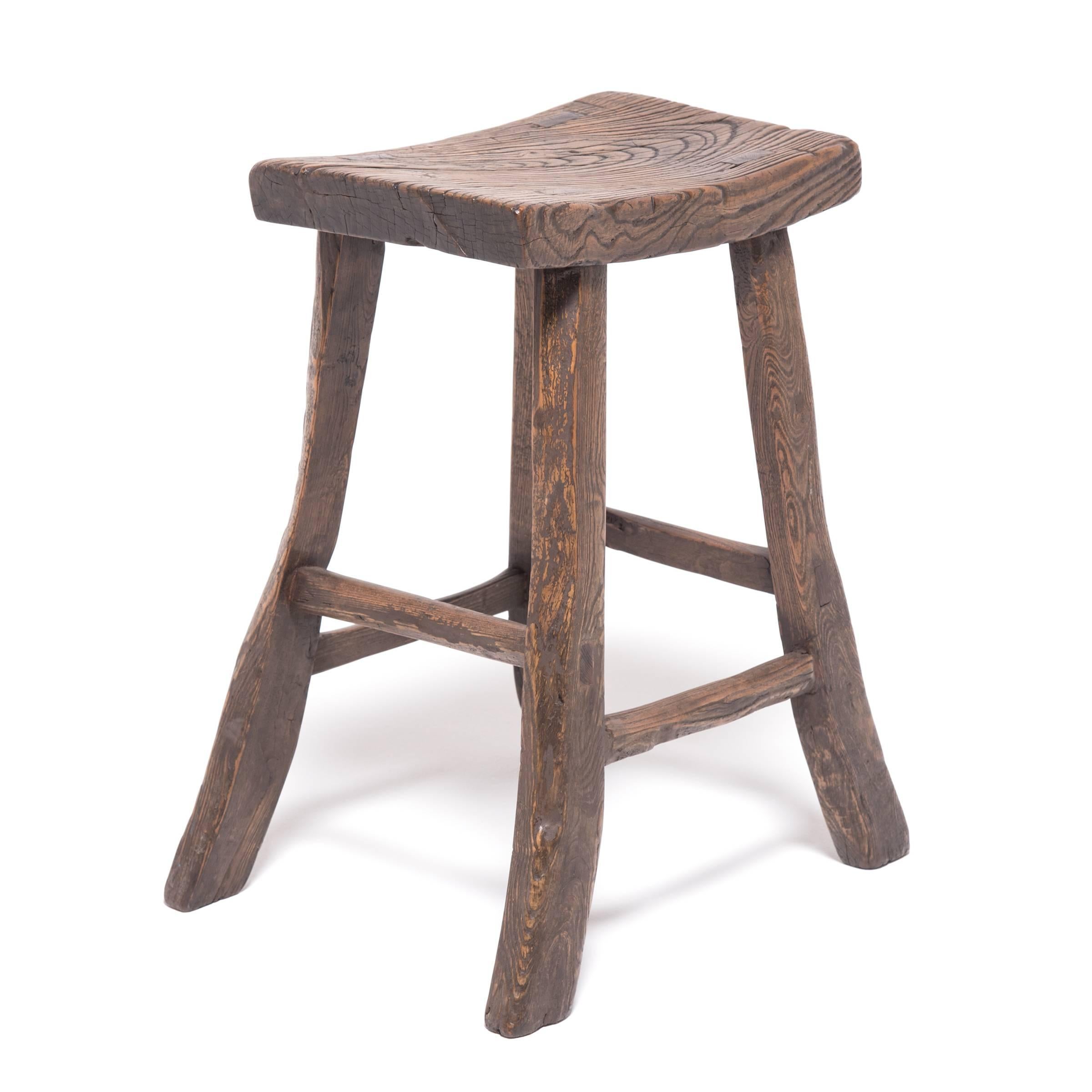 Dynamic and fluid, this Qing-dynasty stool shapes a crescent-curved seat supported by flared legs and horizontal stretcher bars. Time has deepened the contrast of the wood’s gorgeous grain and burnished the surface to a subtle gloss, giving this