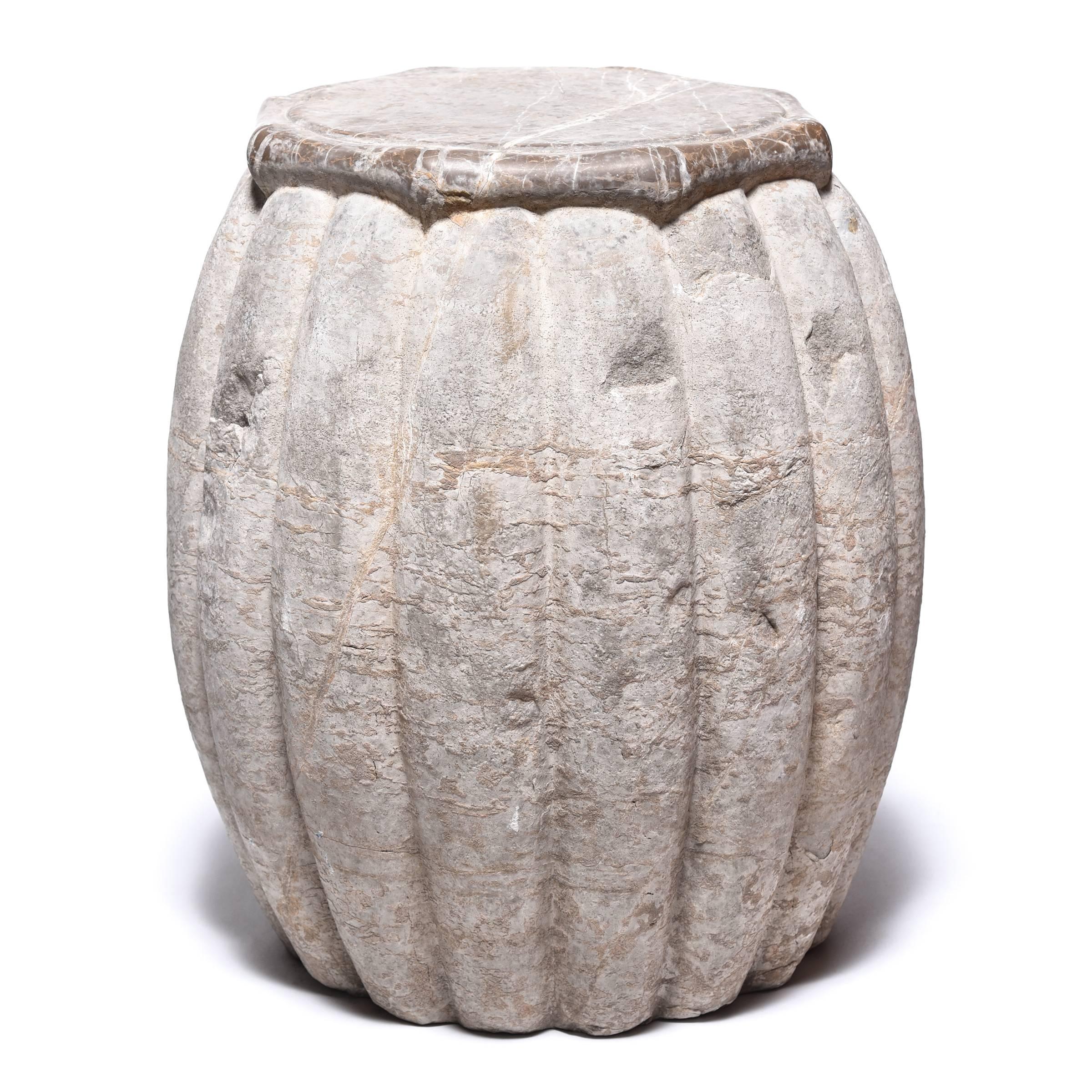 Hand-carved from limestone, this drum-shaped stool swells a ribbed melon shape, an ancient symbol of fertility. A smooth top with bamboo-like trim juxtaposes nicely with the drum’s organic grain and markings, while providing a level surface. We love