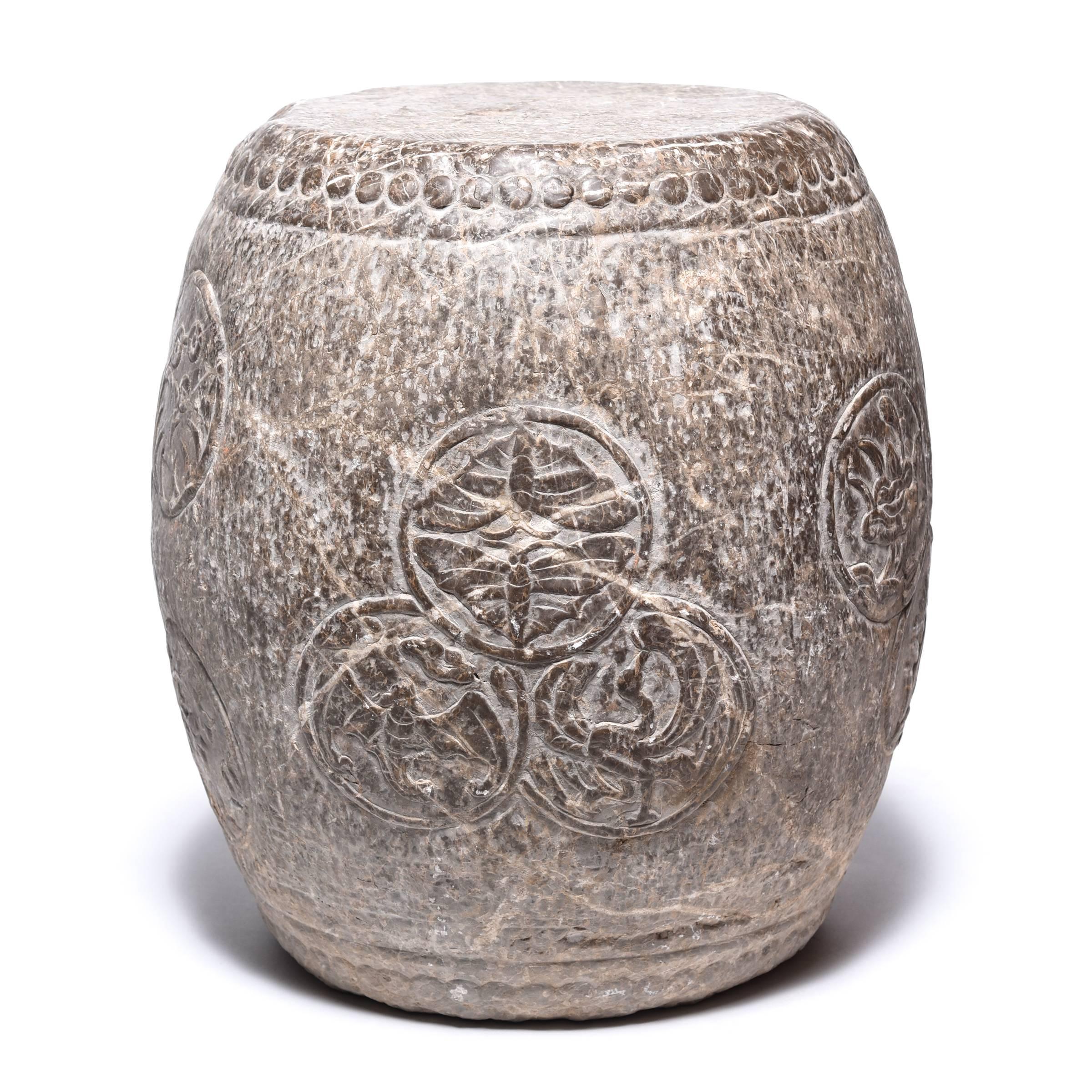 Circular charms adorn the graceful swell of this elegant stone drum stool. An encircled bat symbolizes happiness and joy, while a phoenix represents the spiritual union of yin and yang. Paired butterflies recall an ancient folktale that tells of
