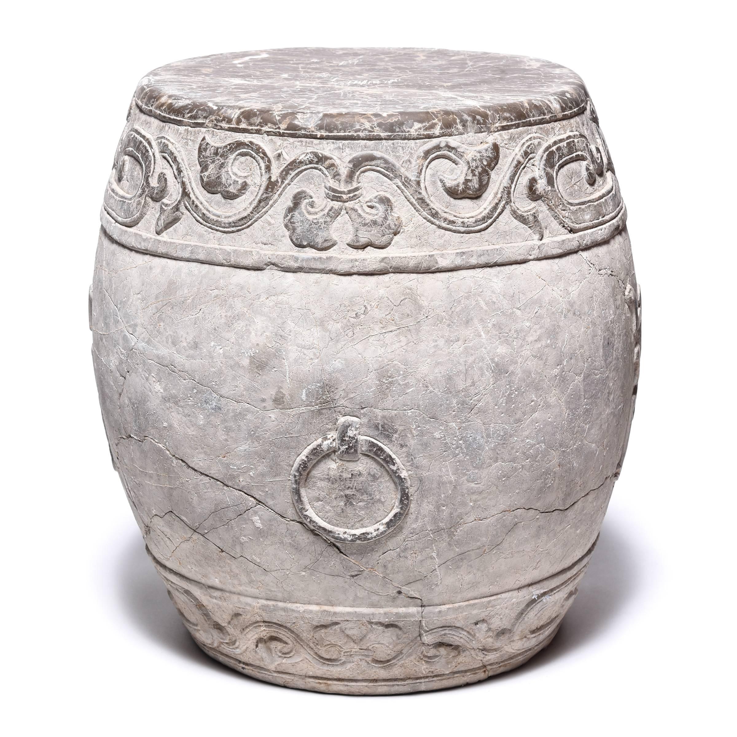 Made in Shanxi province, this venerable drum stone was hand-carved with a trailing vine motif and an auspicious “fu” character representing prosperity. Polishing brings out the intricate relief carving and smoothes the top, making the drum a lovely