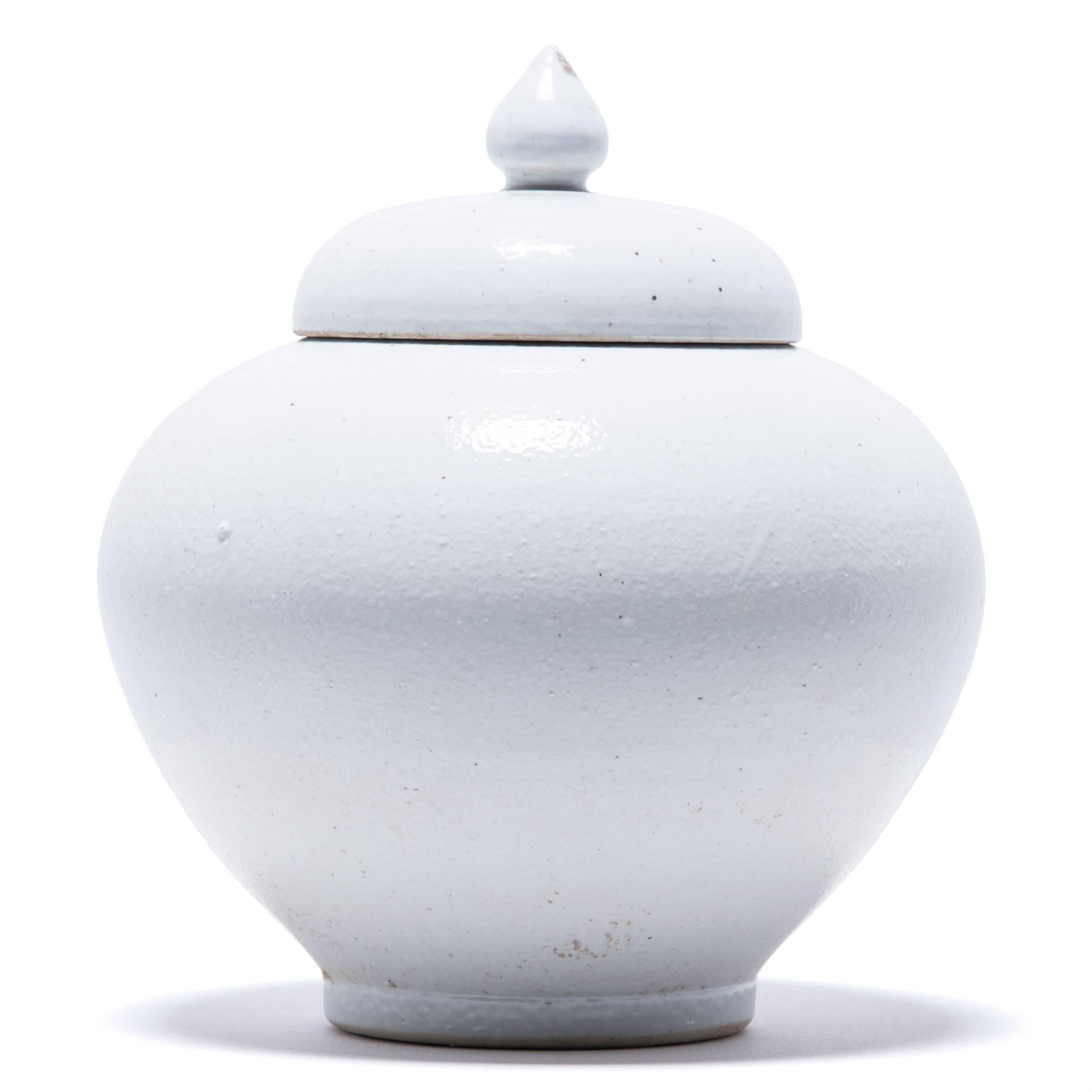 Made in Jiangxi province in 2015, this stunning lidded jar reinterprets traditional Chinese ceramic design with simplified lines. A clean, white glaze calls attention to the jar’s undulating curves.

      