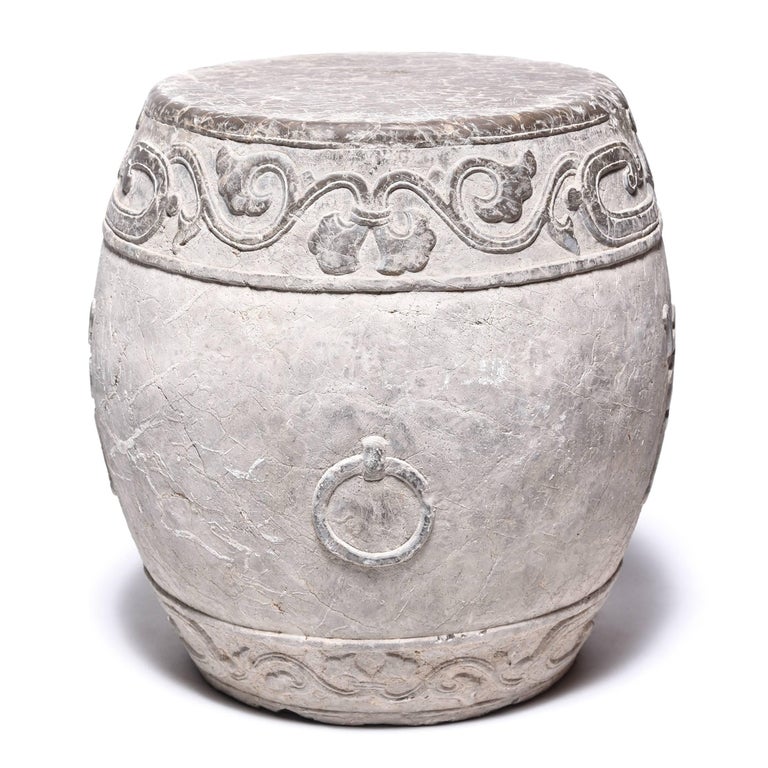 Made in Shanxi province, this venerable drum stone was hand-carved with a trailing vine motif and an auspicious “fu” character representing prosperity. Polishing brings out the intricate relief carving and smoothes the top, making the drum a lovely