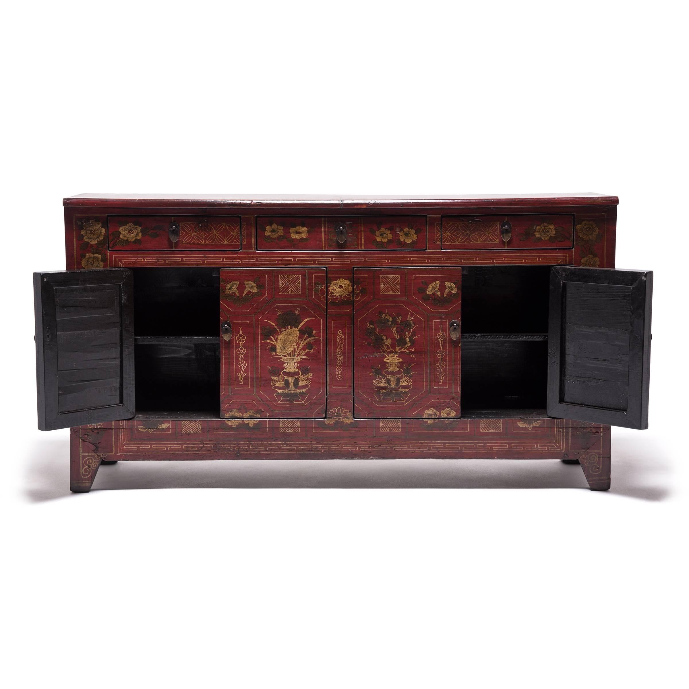 A skilled Mongolian artisan made this beautiful, antique cabinet. The craftsmanship is evident in the intricately painted floral designs and concealed hinges and joinery. The cabinet is painted with distinctively eastern aesthetic, but the simple,