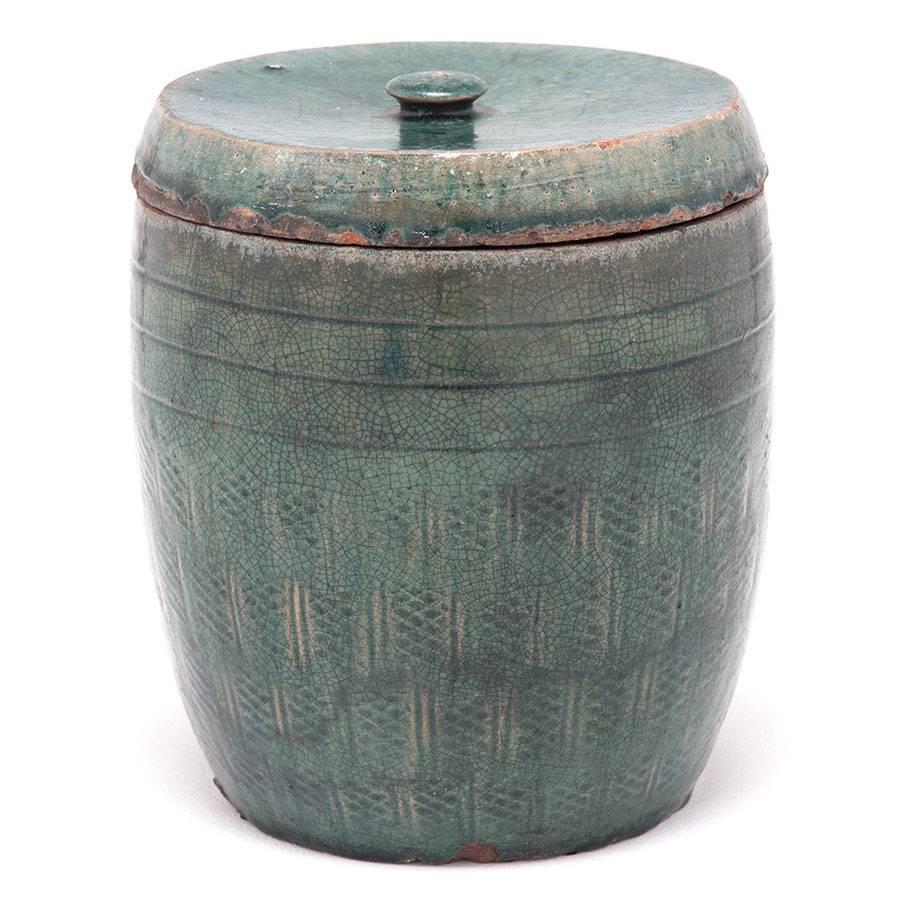 Over a century ago the walls of an apothecary shop in Northern China were lined with this and other earthenware jars, which were filled with every type of curative flora and fauna. This jar has a beautiful crackled green glaze with subtle snakeskin