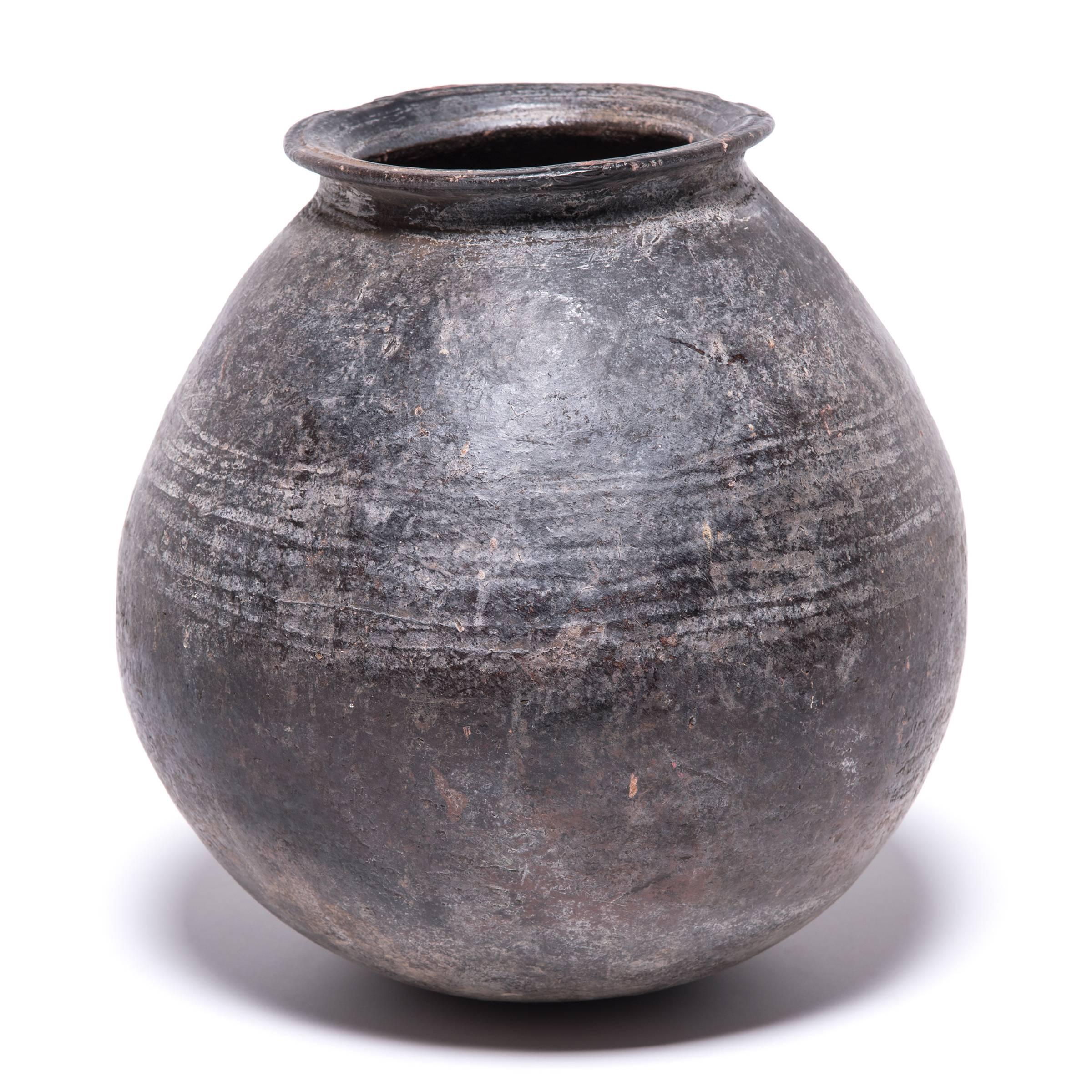 The Nupe people of Nigeria were touted as some of the finest ceramicists in Africa. The form and glaze of the vessel's lip marks it as an early example of their craft. Everyday objects, like this water vessel, received detailed attention. The
