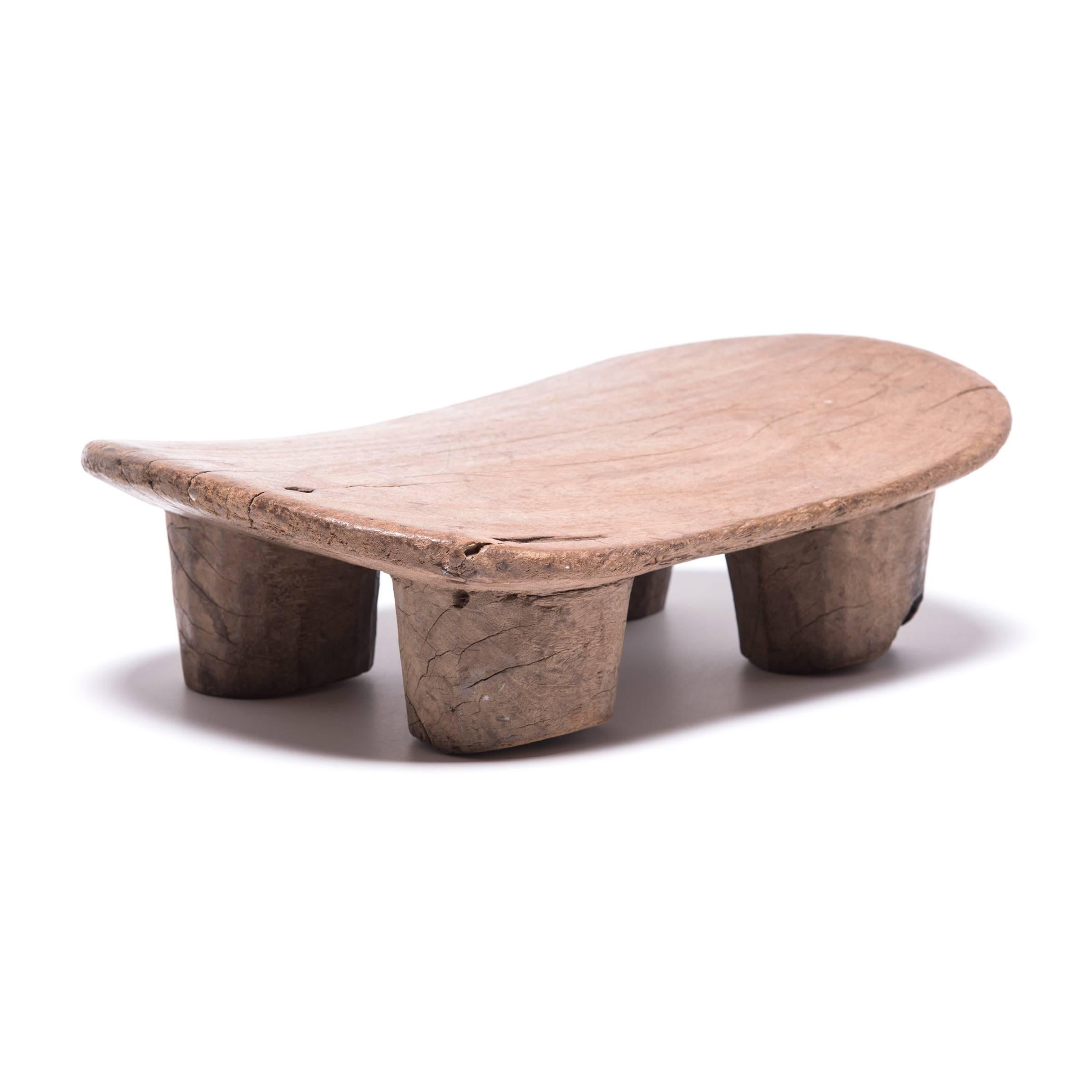 Hand-carved from a single, solid block of wood, each Senufo stool retains a unique personality as a modern sculpture, seat, or table. The irregular strokes and diminutive nature are telltale signs of this traditional woodcarving practice. The