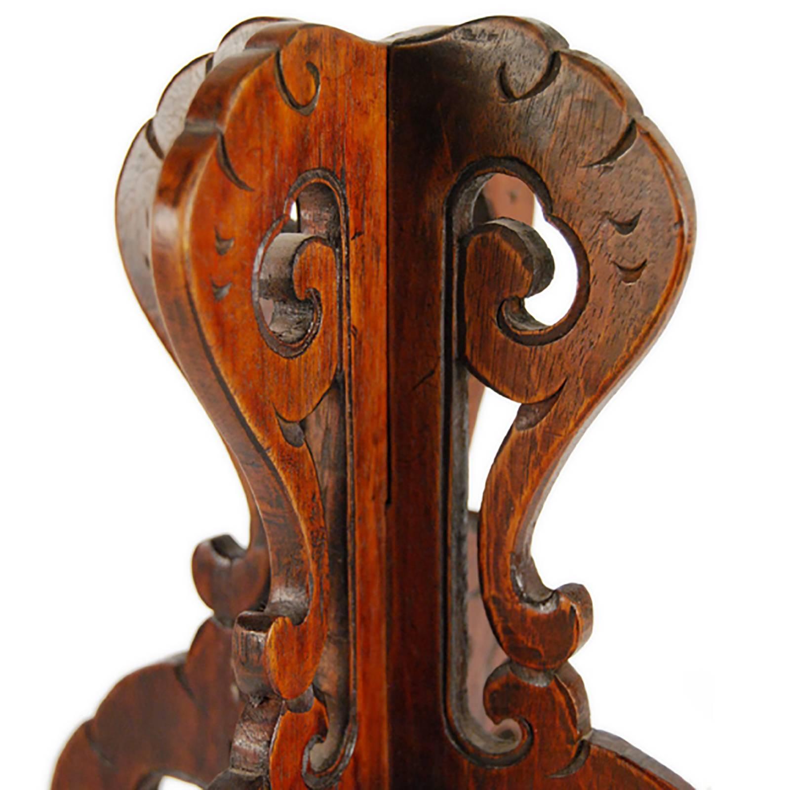 Out of context, this carved wood hat stand has a curious, octopus-like appearance. Intricately embellished with carved flourishes, the hat Stand displays the opulence of court fashion, where rank and status was expressed through fashion and its