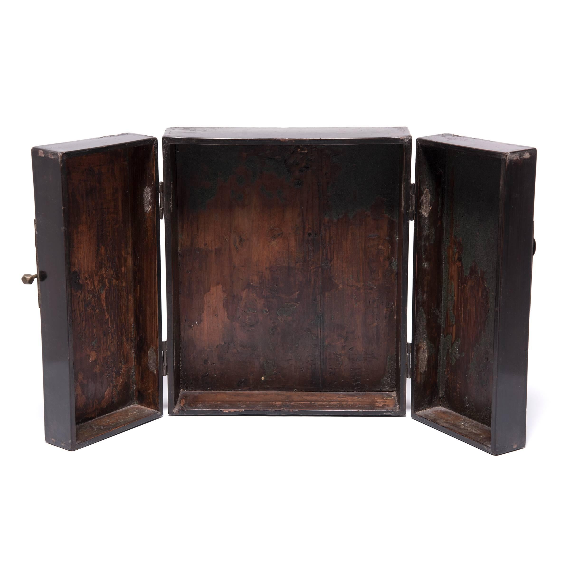 Made of Chinese northern elm, this altar cabinet once contained the essentials for ancestor rituals. Although darkened with age, the cabinet’s two doors still bear the dynamic brushwork and vivid color of its painted floral decoration. Its