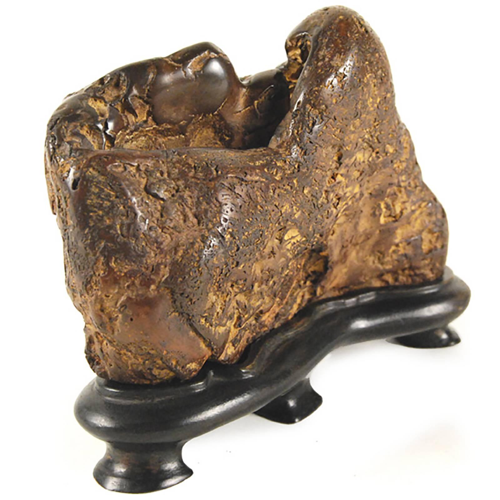 A Qing-dynasty scholar would have used this organically shaped brush washer to rinse the ink from his calligraphy brush. Made of jasper, the vessel’s naturally gnarled shape showcases the stone’s speckled appearance. Such novelties inspired scholars