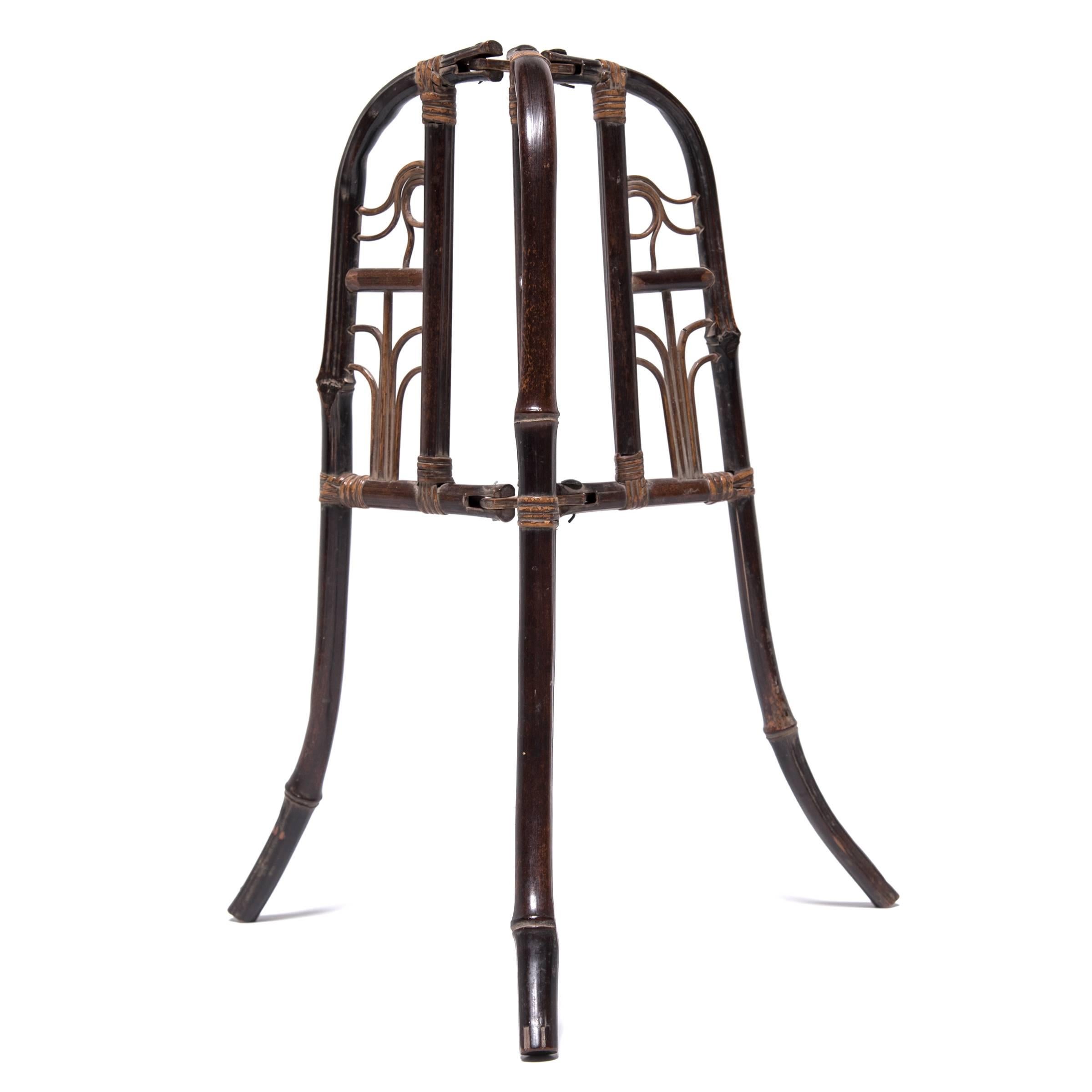 In 19th century China, government officials wore different hats to show their various ranks of office—the styles and designs changed depending on the season. This one-of-a-kind folding hat stand, finely crafted out of bamboo, dates to the Qing