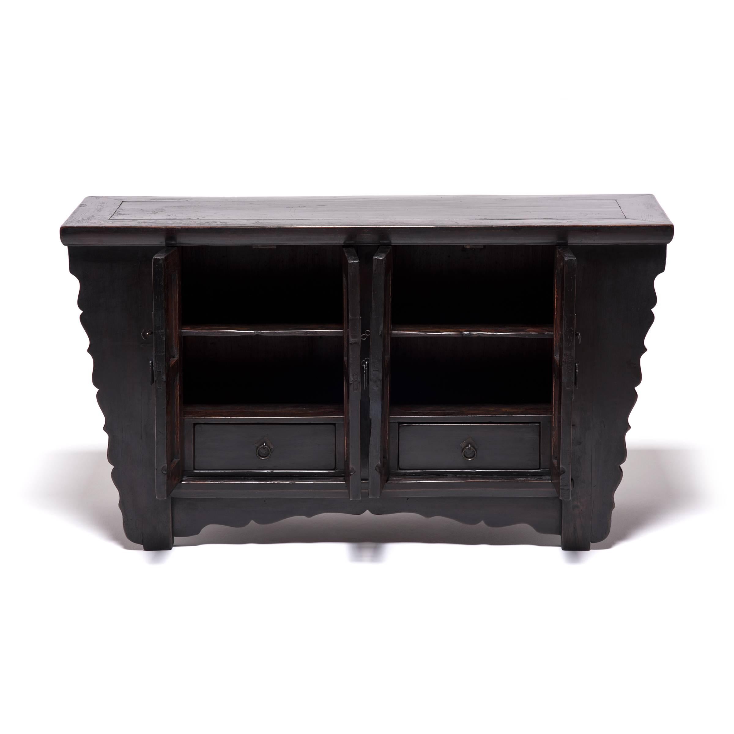 This twin-door coffer gets a lyrical lift from its undulating scalloped edges. Expertly constructed without a nail or screw, it was hand built over a century ago with traditional mortise-and-tenon joinery, the ultimate standard for fine carpentry.