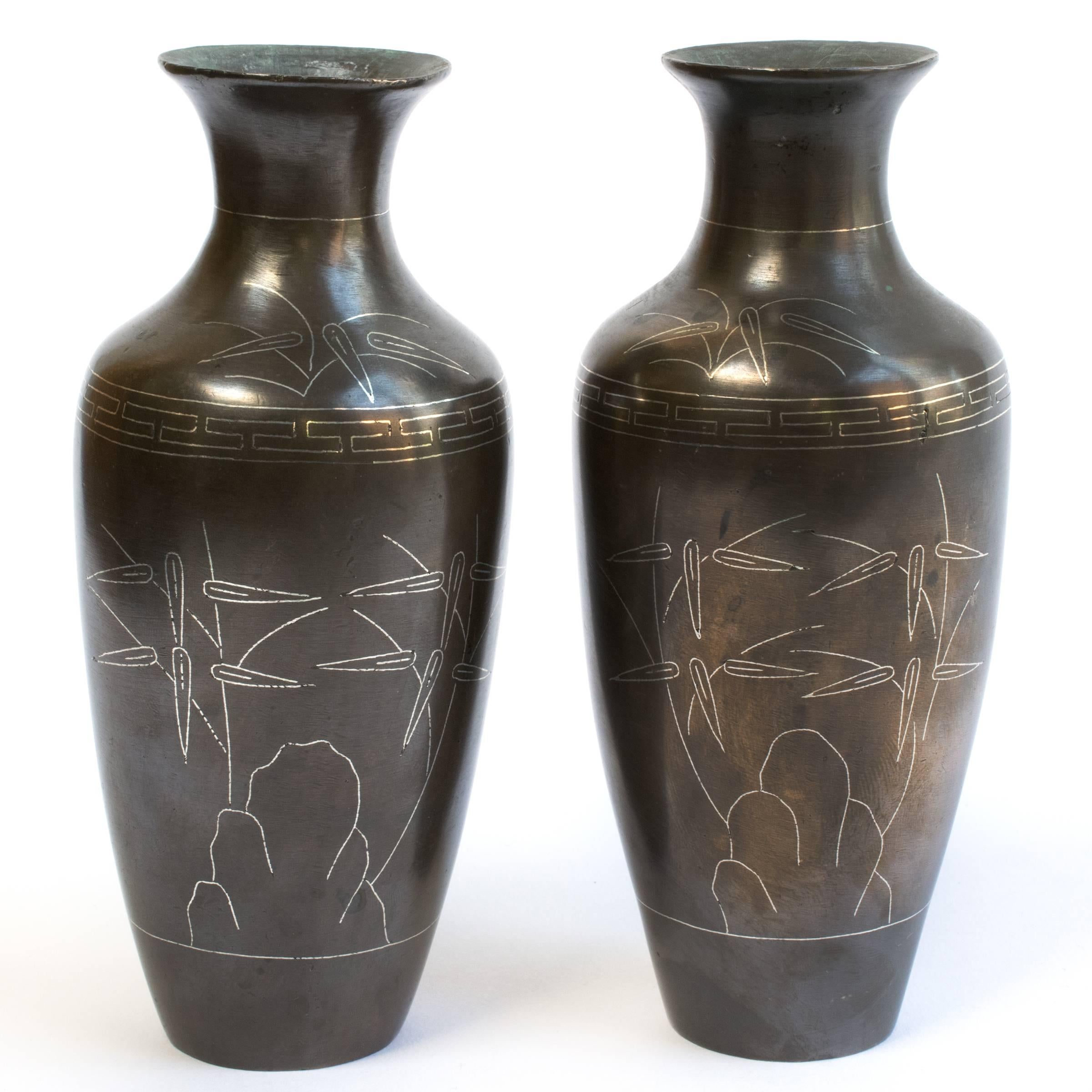 With a flaring lip and striking profile, connoisseurs often refer to these exquisite vases as “turnip-shaped”. Each was crafted out of bronze over two centuries ago, and is decorated with a silver inlay garden scene. The bases are signed with the