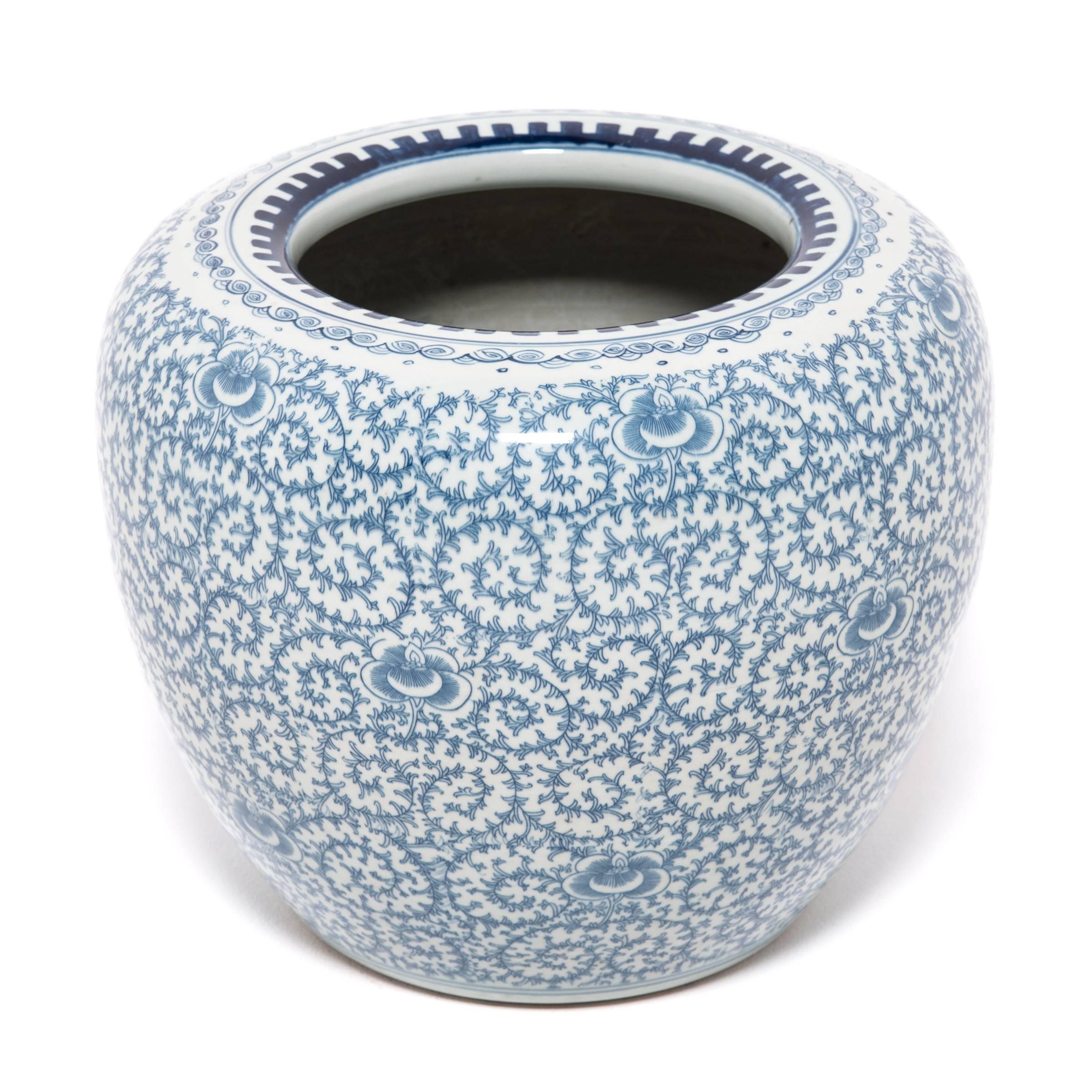 A brilliant example of traditional blue-and-white porcelain, this exquisitely decorated bowl begs close inspection to appreciate its intricate vine detail. Punctuated with the occasional violet-like bloom, the decoration possesses a lively rhythm