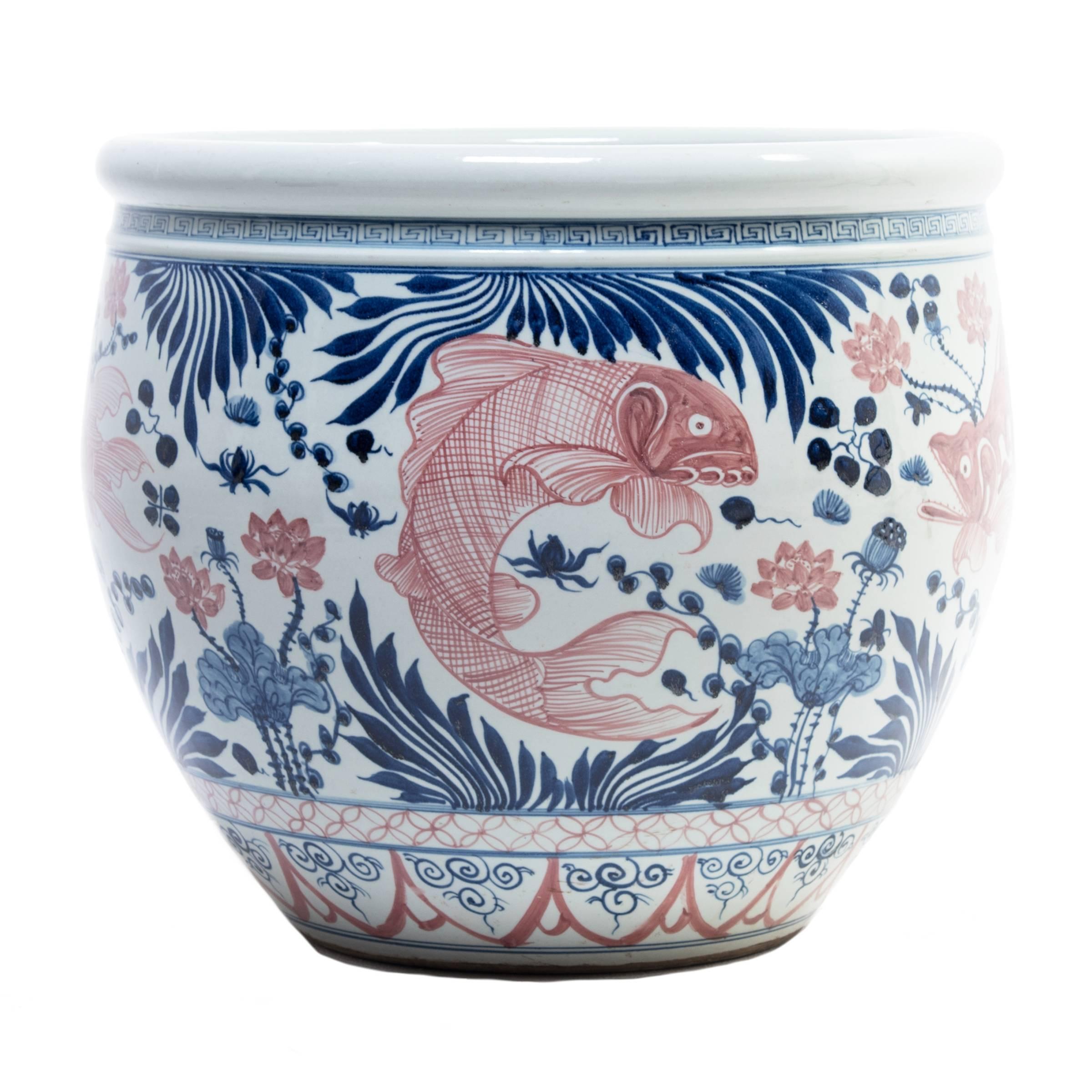 A modern artisan from China’s Zhejiang region made this ceramic basin, but the blue and white style is centuries older and reflects Classic Ming dynasty designs. The whimsical fish swimming among delicately painted cobalt blue plants and fronds is