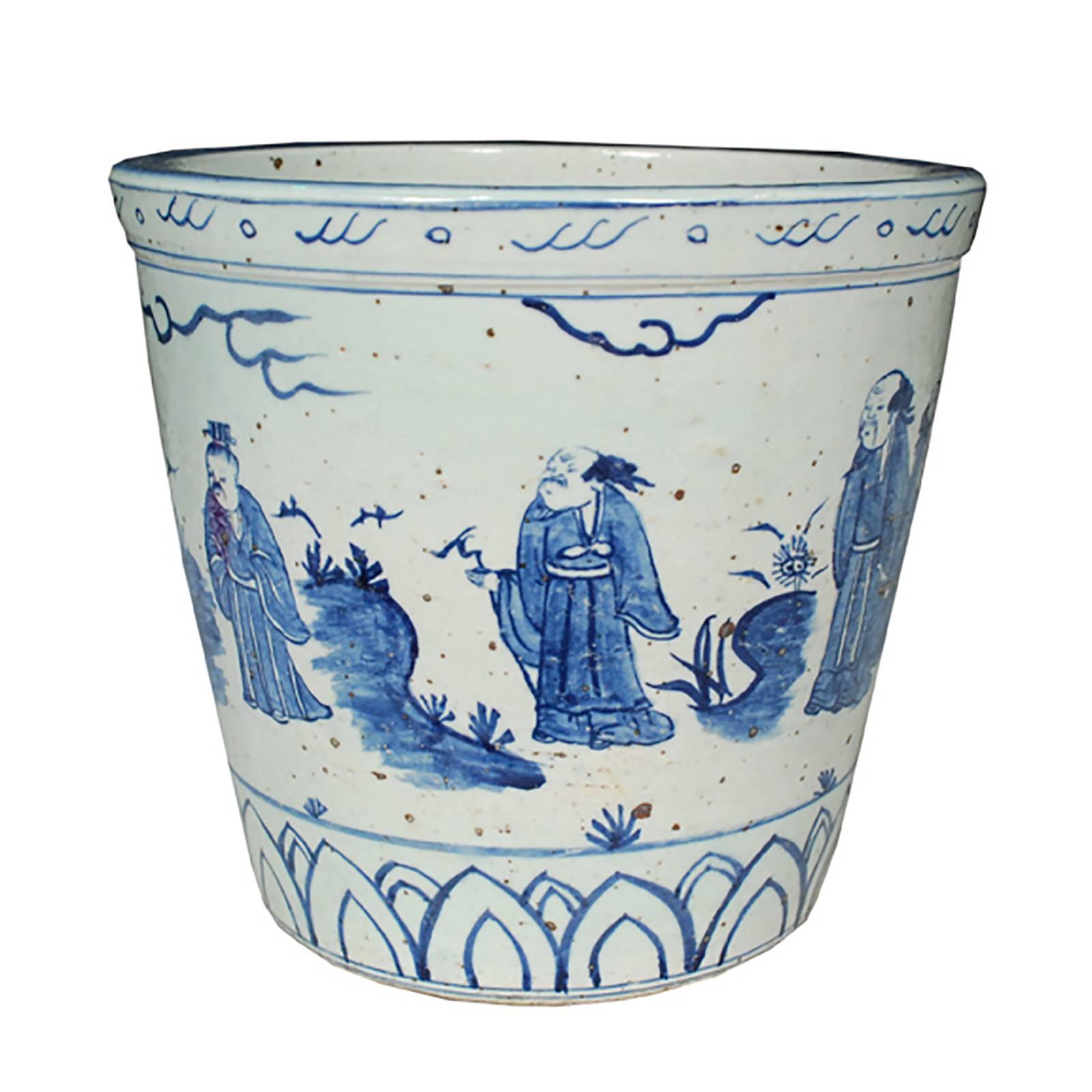 This unique pot was made by hand in southern China, and is a wonderful example of blue and white ceramics that are sought worldwide by collectors. The scene wraps around the entire pot and is painted in rich blue feathery brushstrokes. The figures