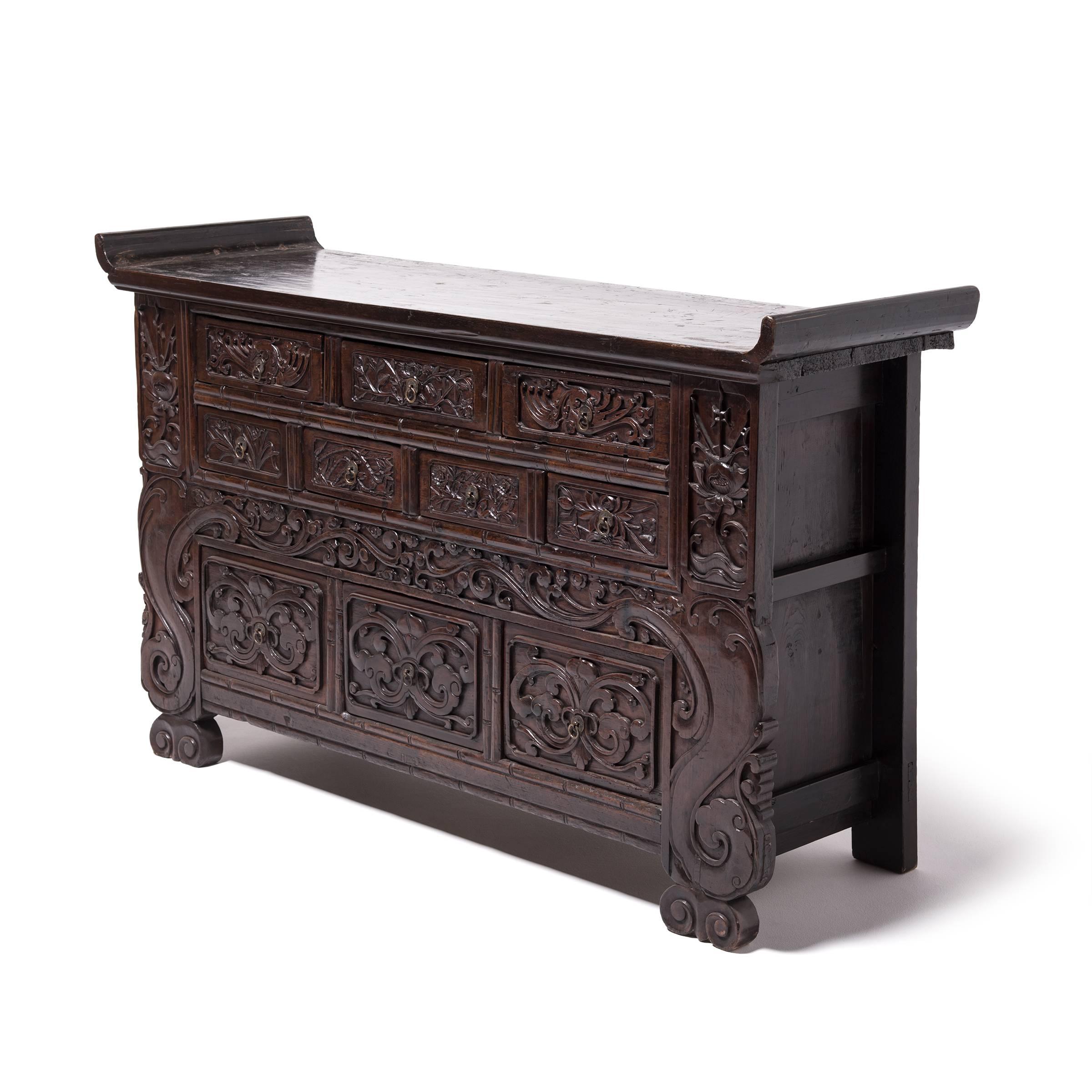 This beautiful chest is a classic Qing dynasty design handcrafted in northern China out of elmwood. The quality of the workmanship is evident in the beautifully carved drawer fronts. The scrolling vine and lotus symbolize purity because the flower