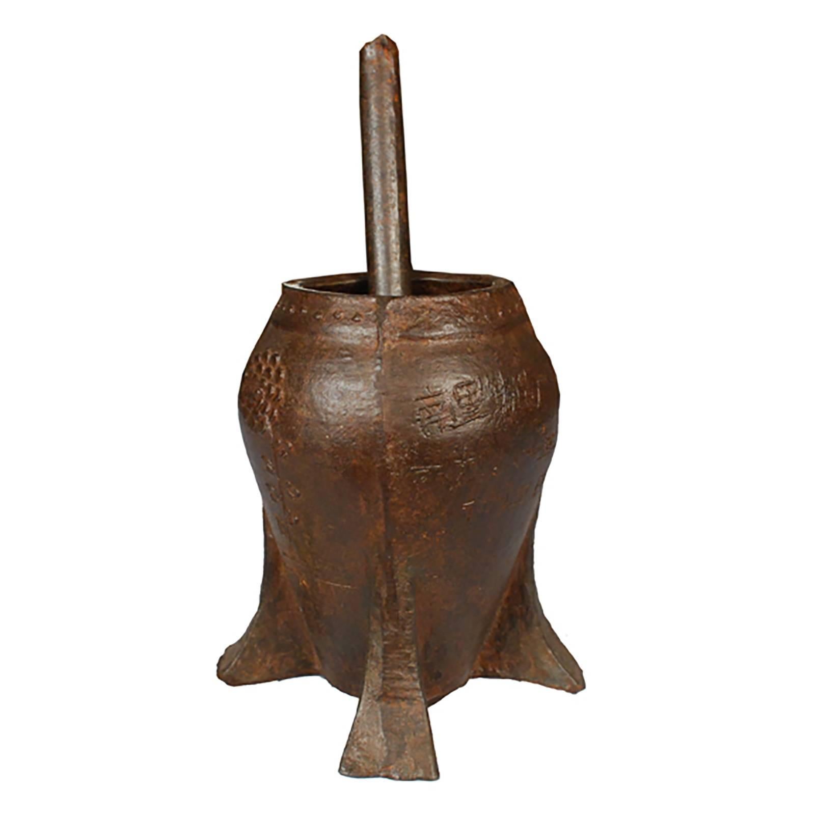 This vintage mortar and pestle from Shanxi, China was cast in iron with a floral relief. It was originally used in a traditional apothecary to create herbal medicine.