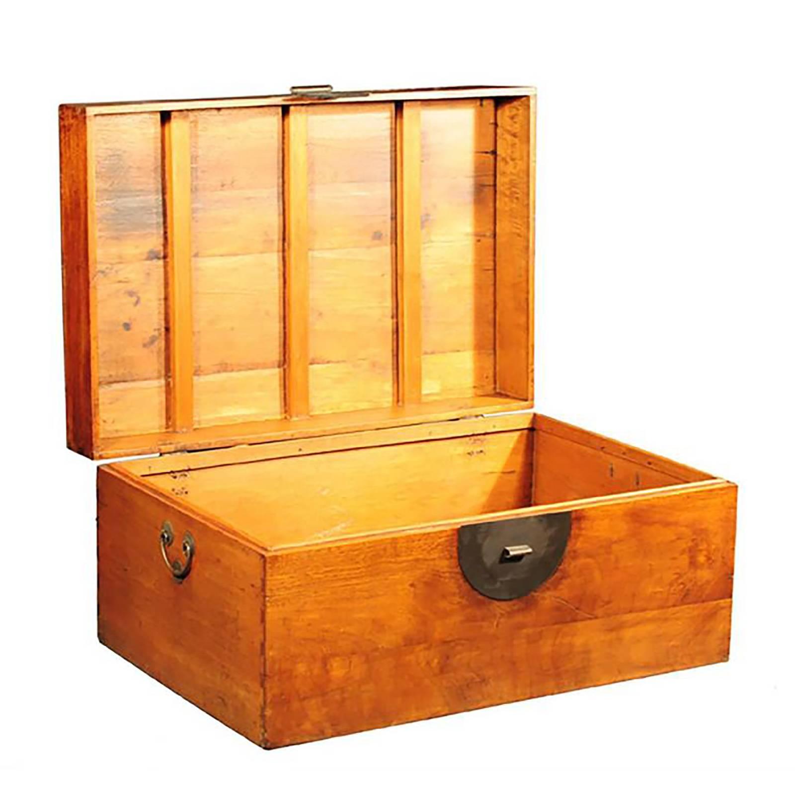 Long ago, a Chinese scholar would have used this trunk to hold and transport heavy books or piles of important manuscripts. Solidly built with a great deal of care, the trunk is constructed out of camphor wood with a polished finish that gives the