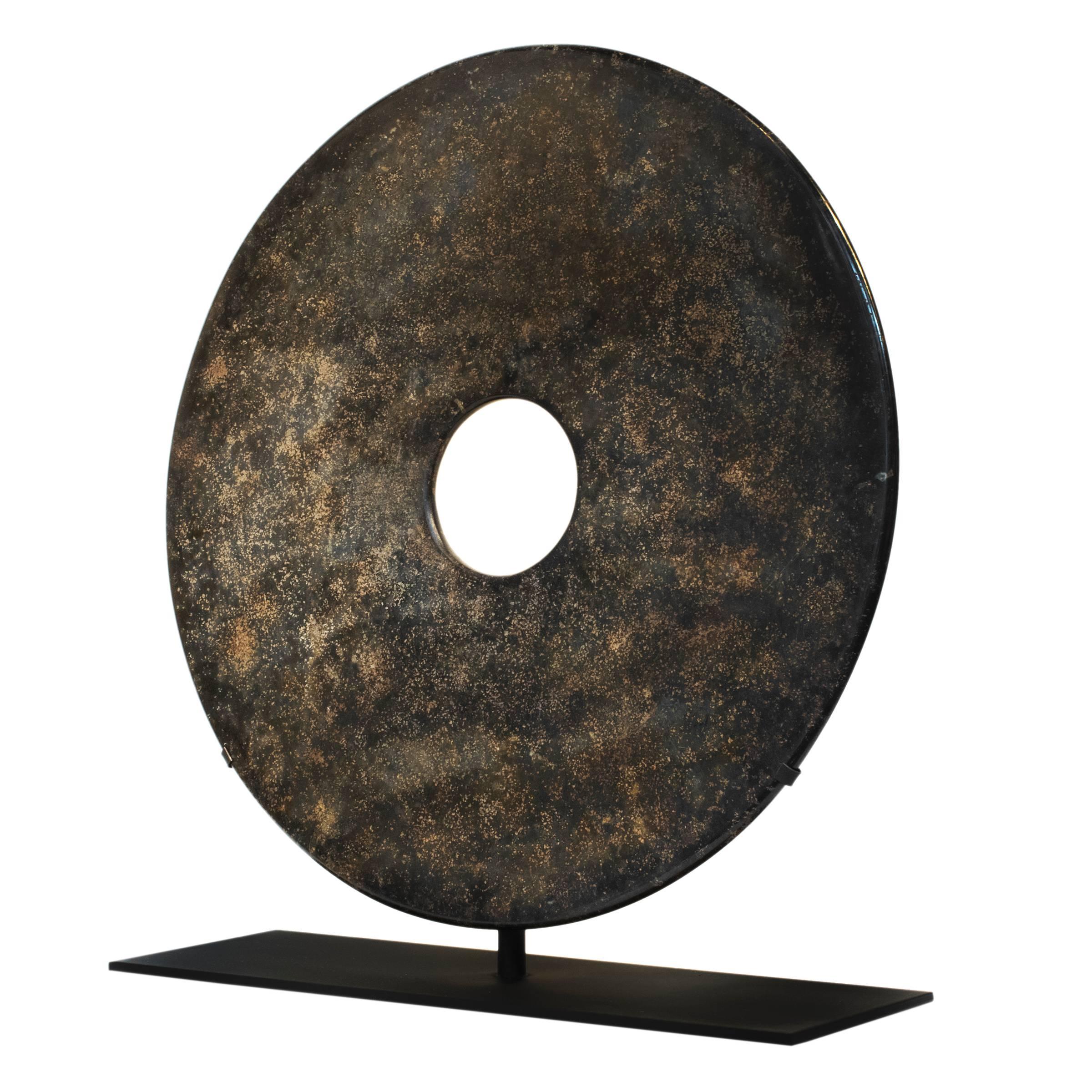 A beautiful carved stone Chinese Bi Disc, a symbol of heaven and wealth, mounted on a custom steel stand.