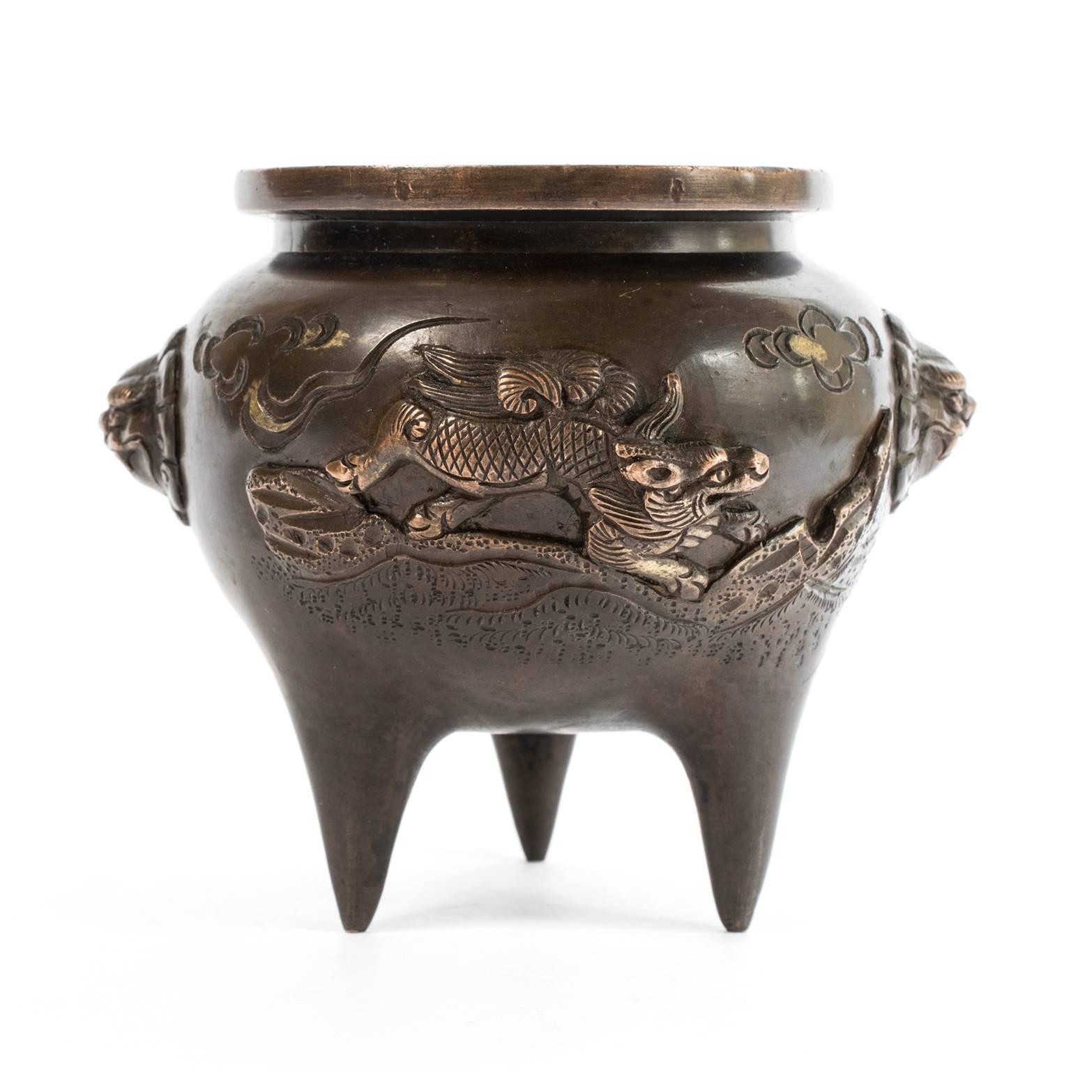 The tripod shape of this finely crafted bronze incense burner is a classical form first appearing in Chinese ceramics and bronzes thousands of years ago. The bronze casting of this burner is exquisite: The monkey and mythical qilin on the surface