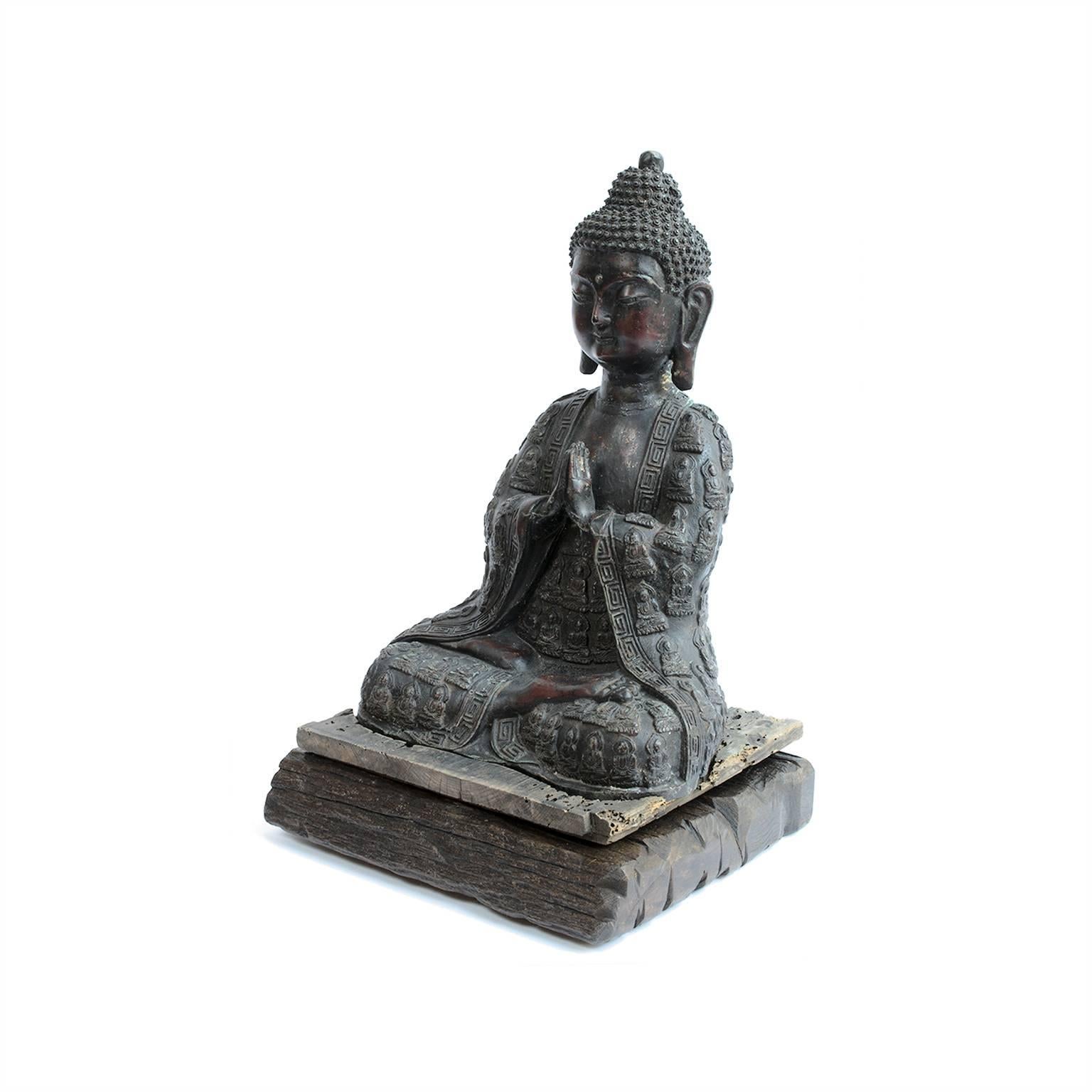 This finely wrought bronze figure, with robes unusually decorated in miniature meditation buddhas, represents the Siddhartha Gautama after he abandoned his life of luxury and the material world to reach enlightenment and become the Sakyamuni Buddha.