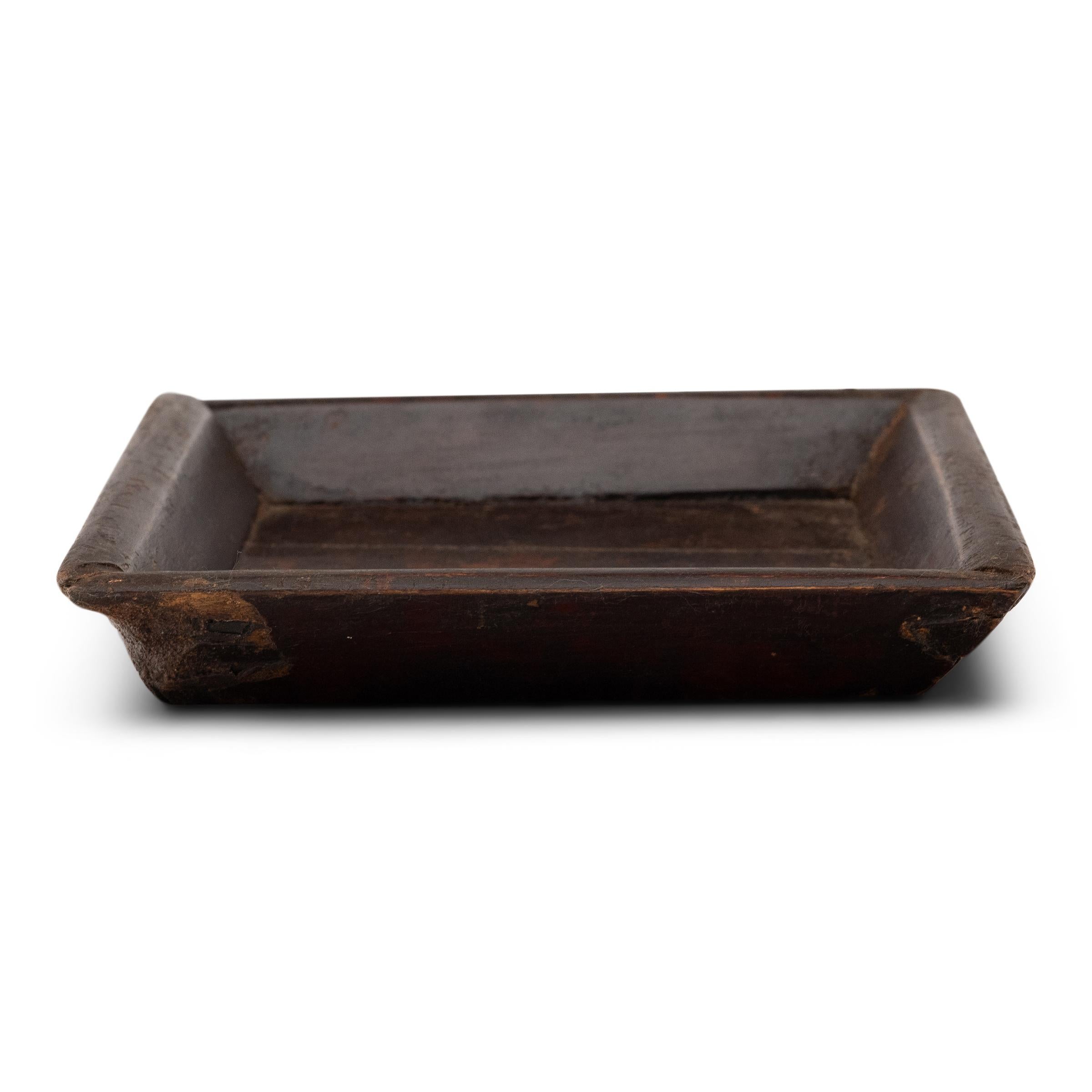 Simple lines, a modest form and a layer of hand-brushed lacquer give this petite Qing-dynasty tray a provincial charm that recalls the warmth of home. The original burgundy lacquer finish has weathered with time for a wabi-sabi feel. Antique iron
