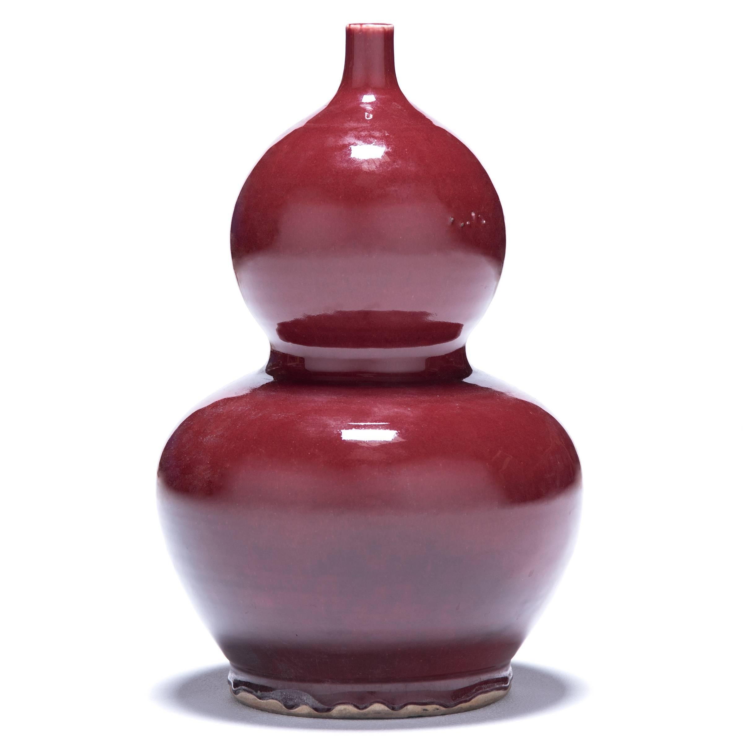 The double gourd is a symbol of fertility considered to be good luck, it is also a Daoist emblem of immortality. Double gourd vases (also called Huluping vases) were invented centuries ago during the Southern Song Dynasty at the Longquan Kiln. These