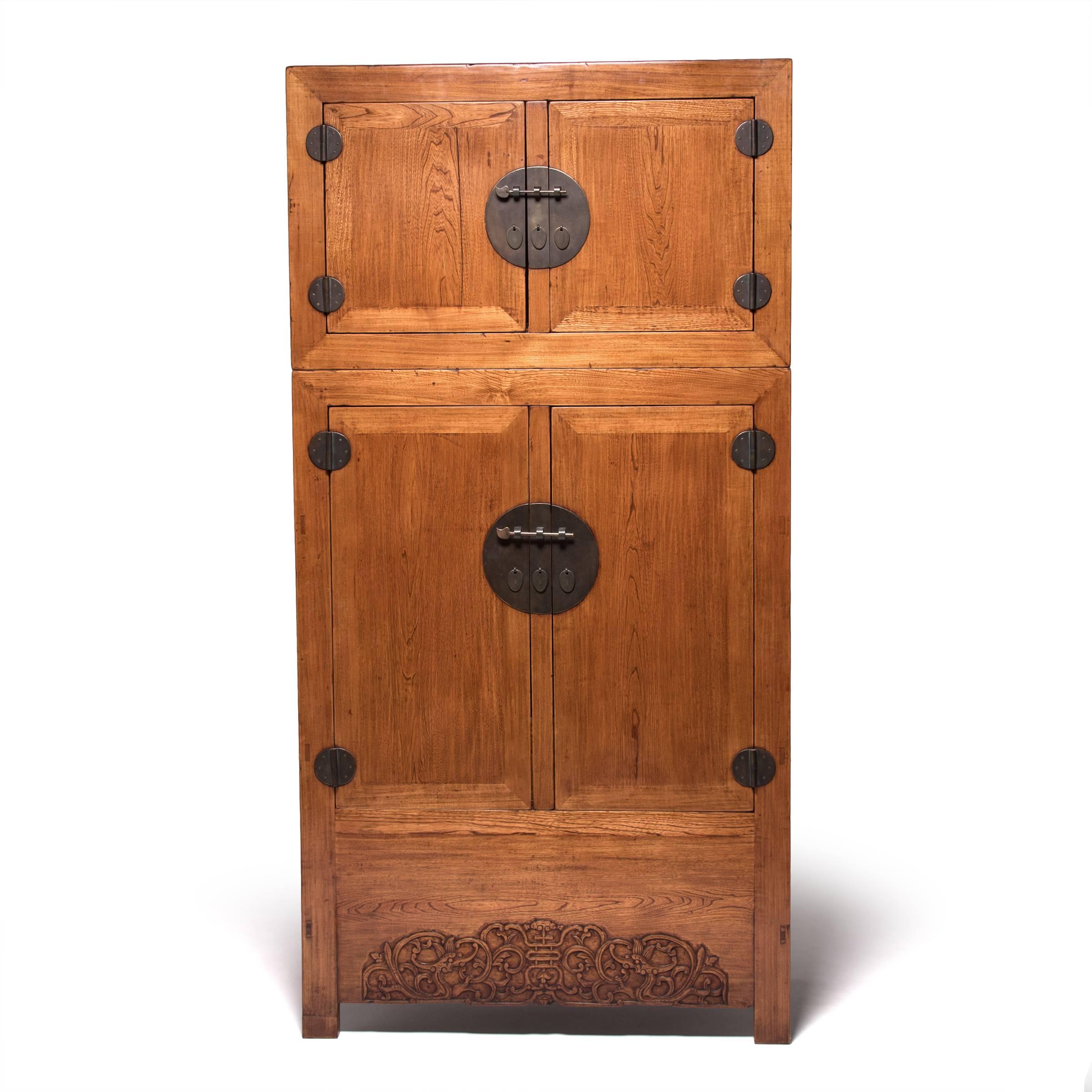 Likely to have been the centerpiece of a wealthy gentleman’s home, this pair of Qing-dynasty compound cabinets are actually comprised of two stacked storage compartments. The upper compartment was traditionally used for hats or out of-season clothes