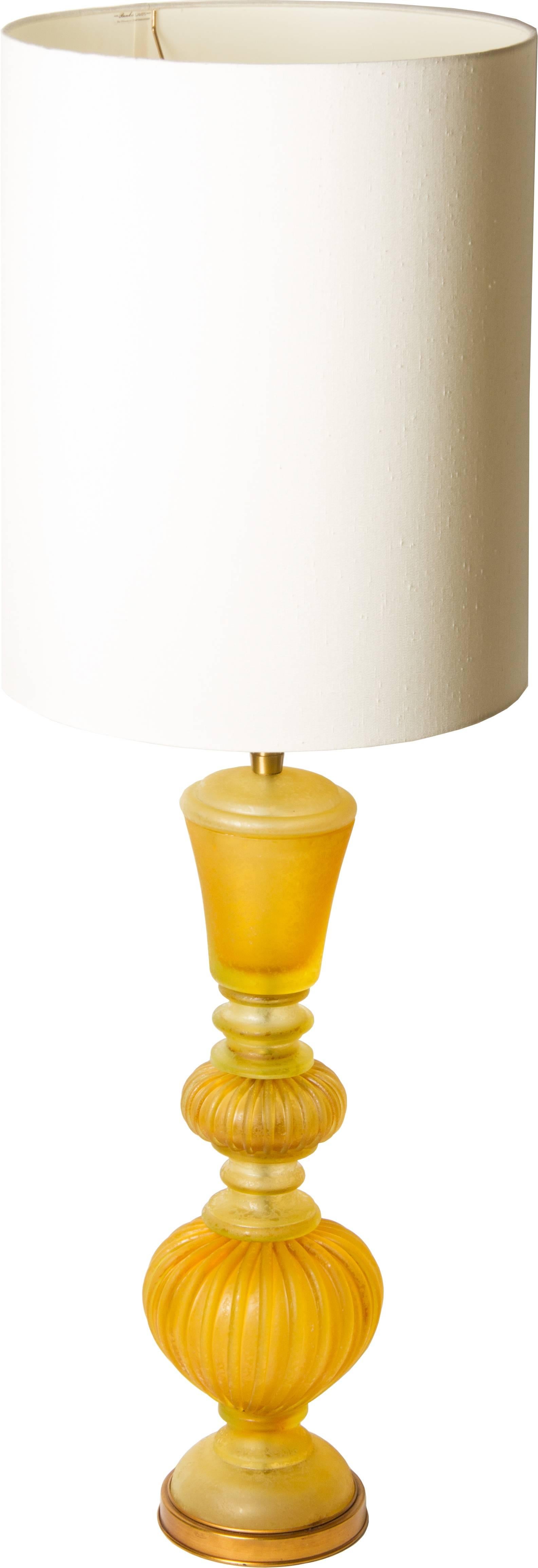 This is a large lamp in a golden color way. The elements vary between a gold to a lemon yellow. The lamp glass itself is 25