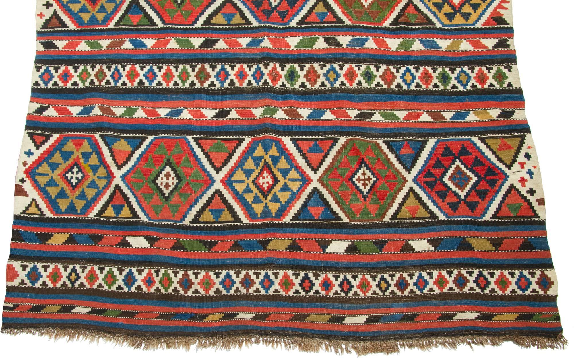 This antique Shirvan rug has an interesting pattern woven with naturally dyed wool.