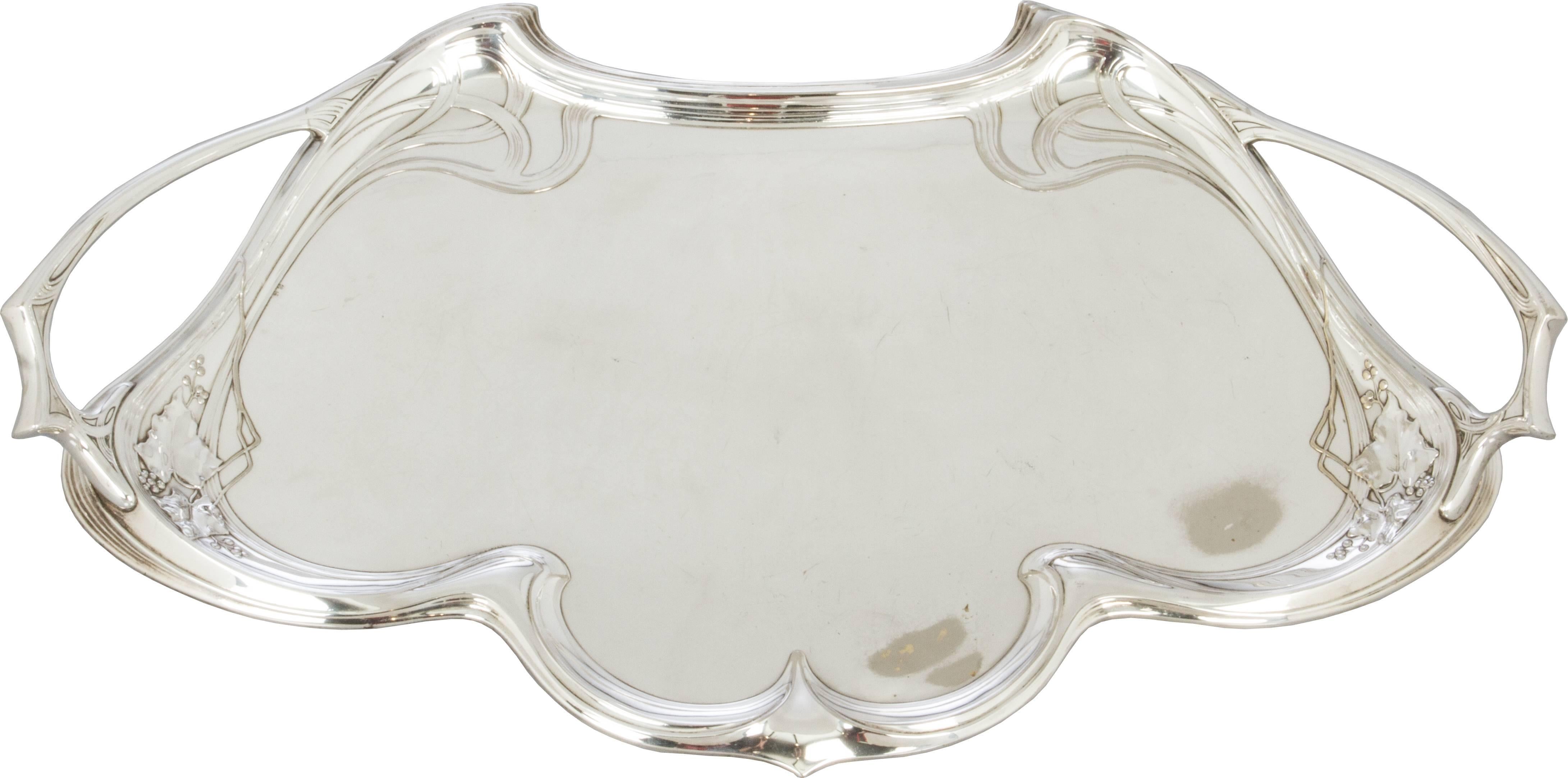 This is a beautiful large stylized handed tray with a floral motif. It is hallmarked with the ostrich, WMF and I/O.