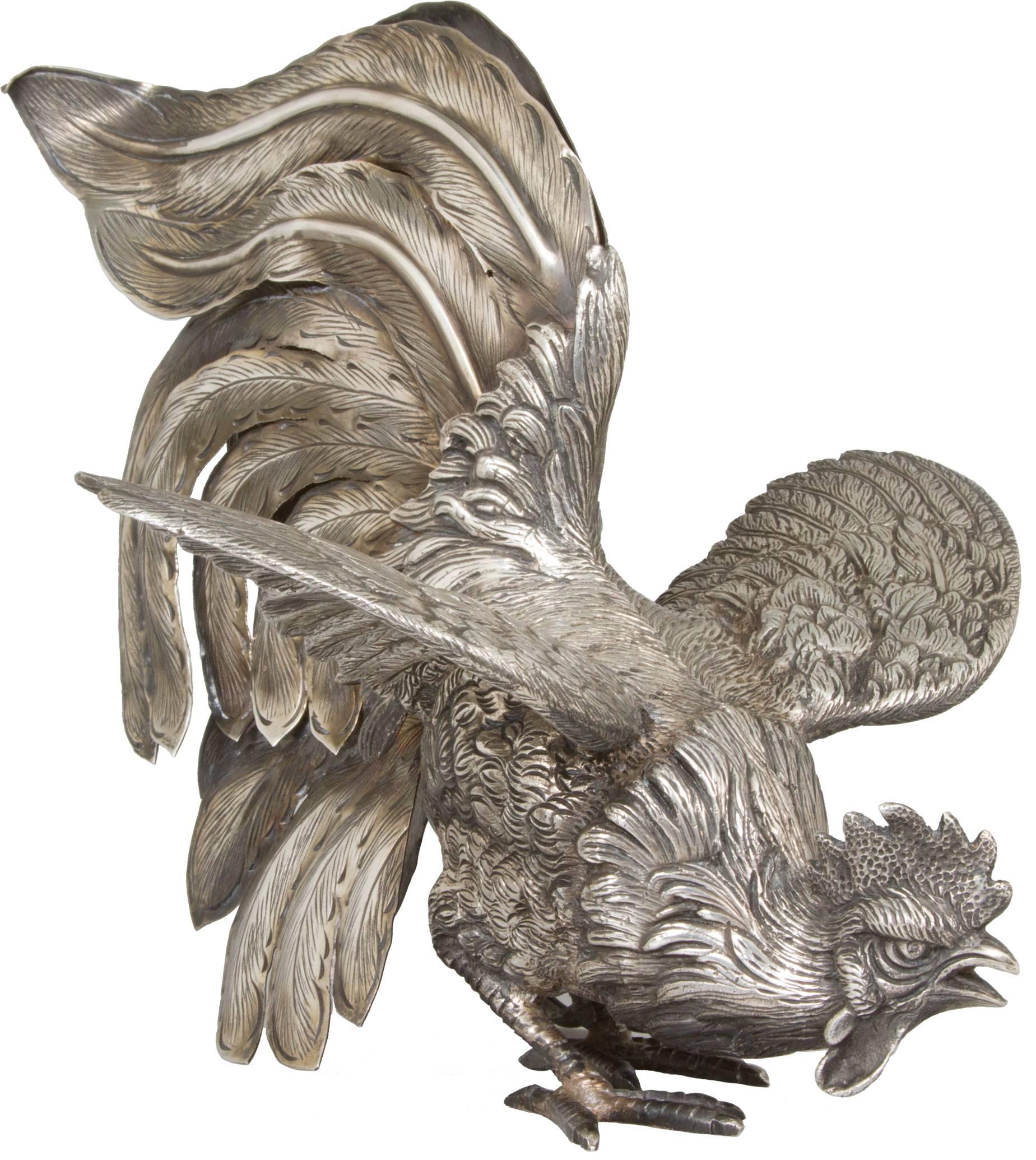 This pair of Camusso sterling silver fighting roosters are intricately cast and detailed. 
Each is marked on the inside back feather, 
