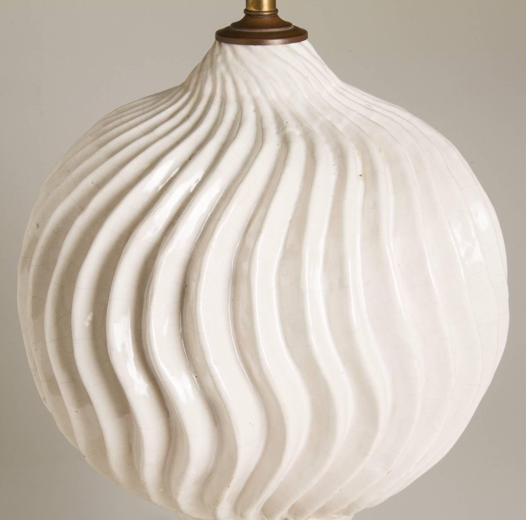 This is a large and sculptural lamp with its matching original finial, having a white crackle glaze and a big presence.