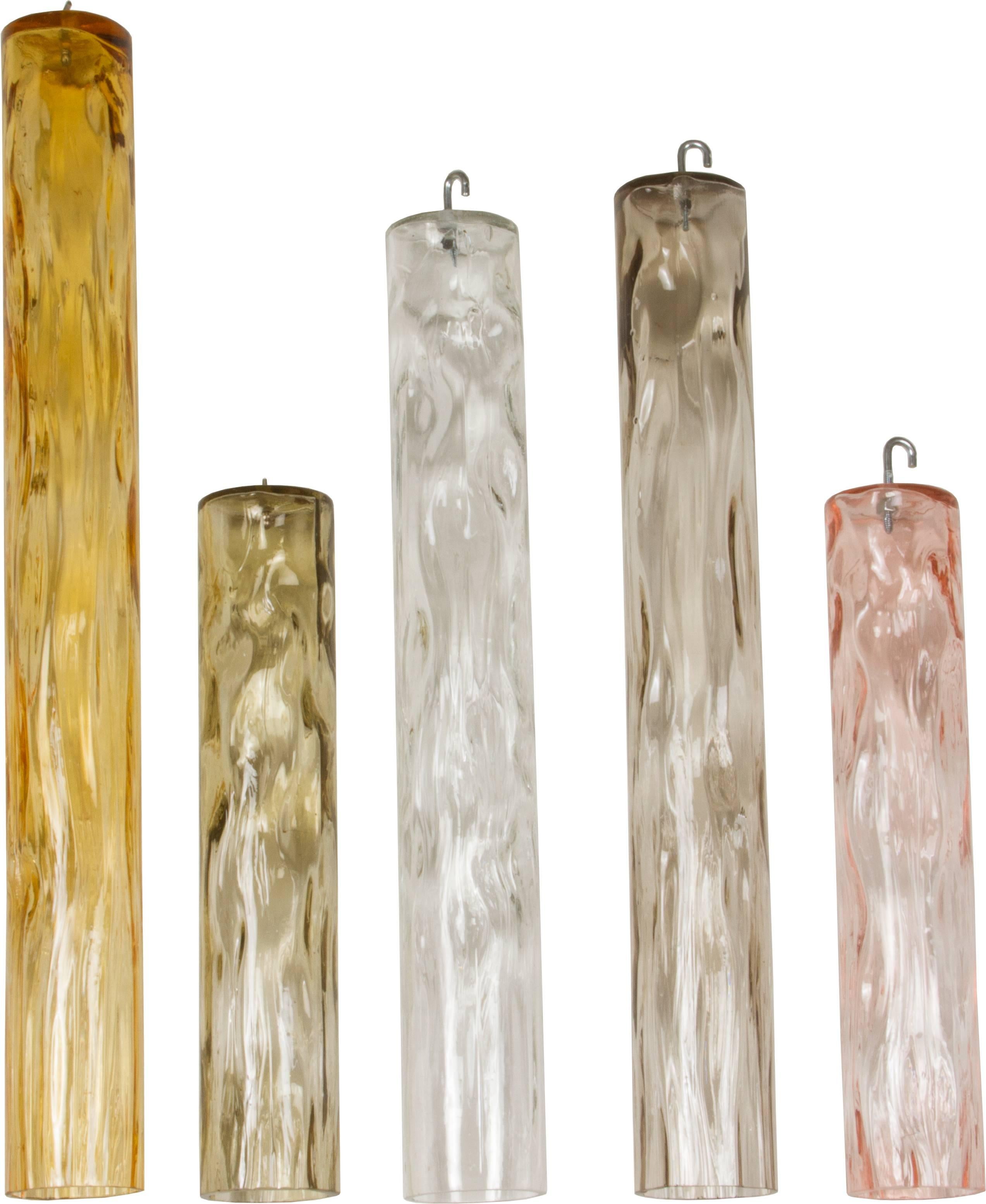 These are an interesting group of glass hanging tubes. They were used as a hanging sculpture and are waiting to be rehung. 

They vary in height from 19