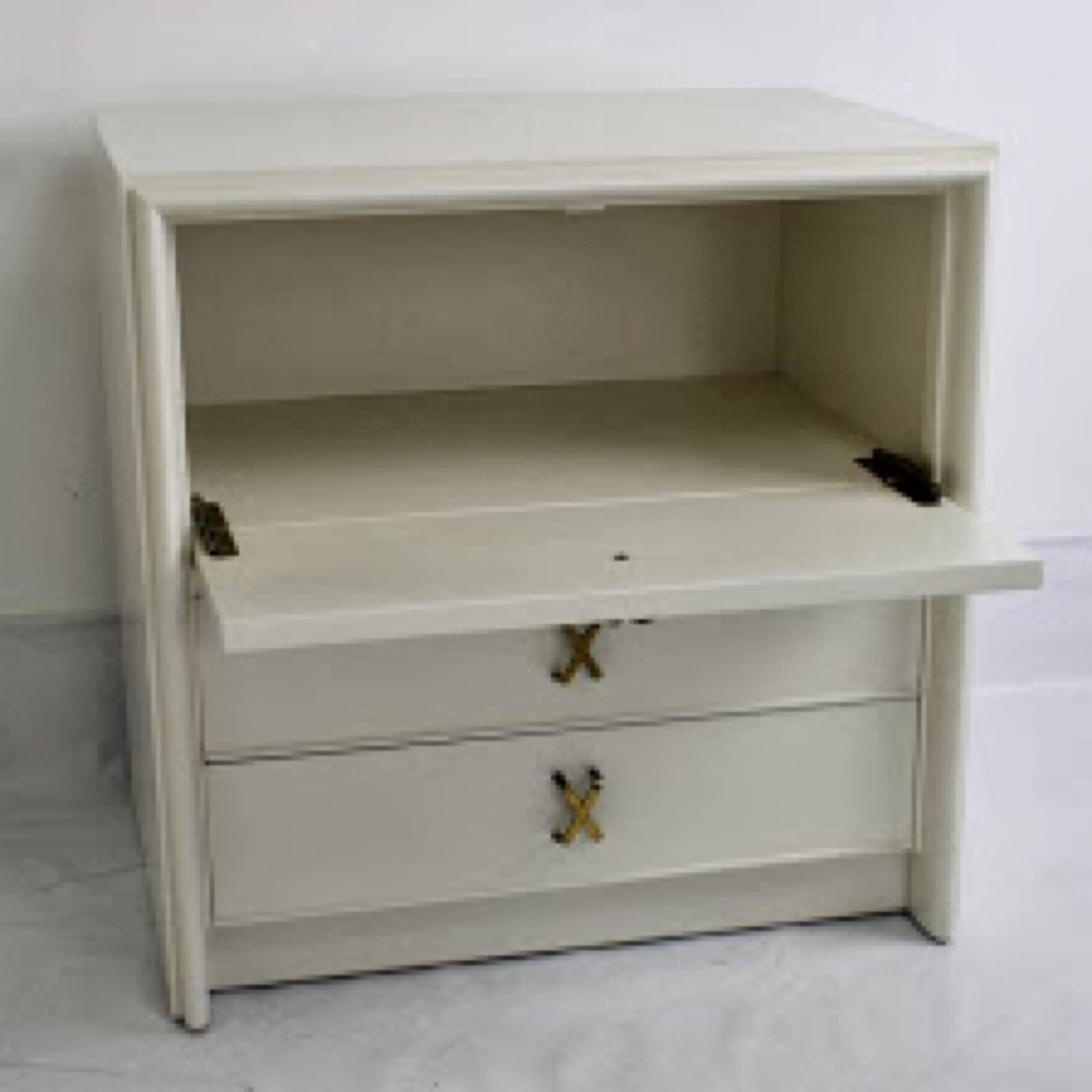 Pair of nightstands or small chests, designed by Paul Frankl for Johnson Furniture. Shown in ivory lacquer but can be finished in custom color with wood stain. Top drawer has drop down feature as a writing surface. Two bottom pull-out drawers below.