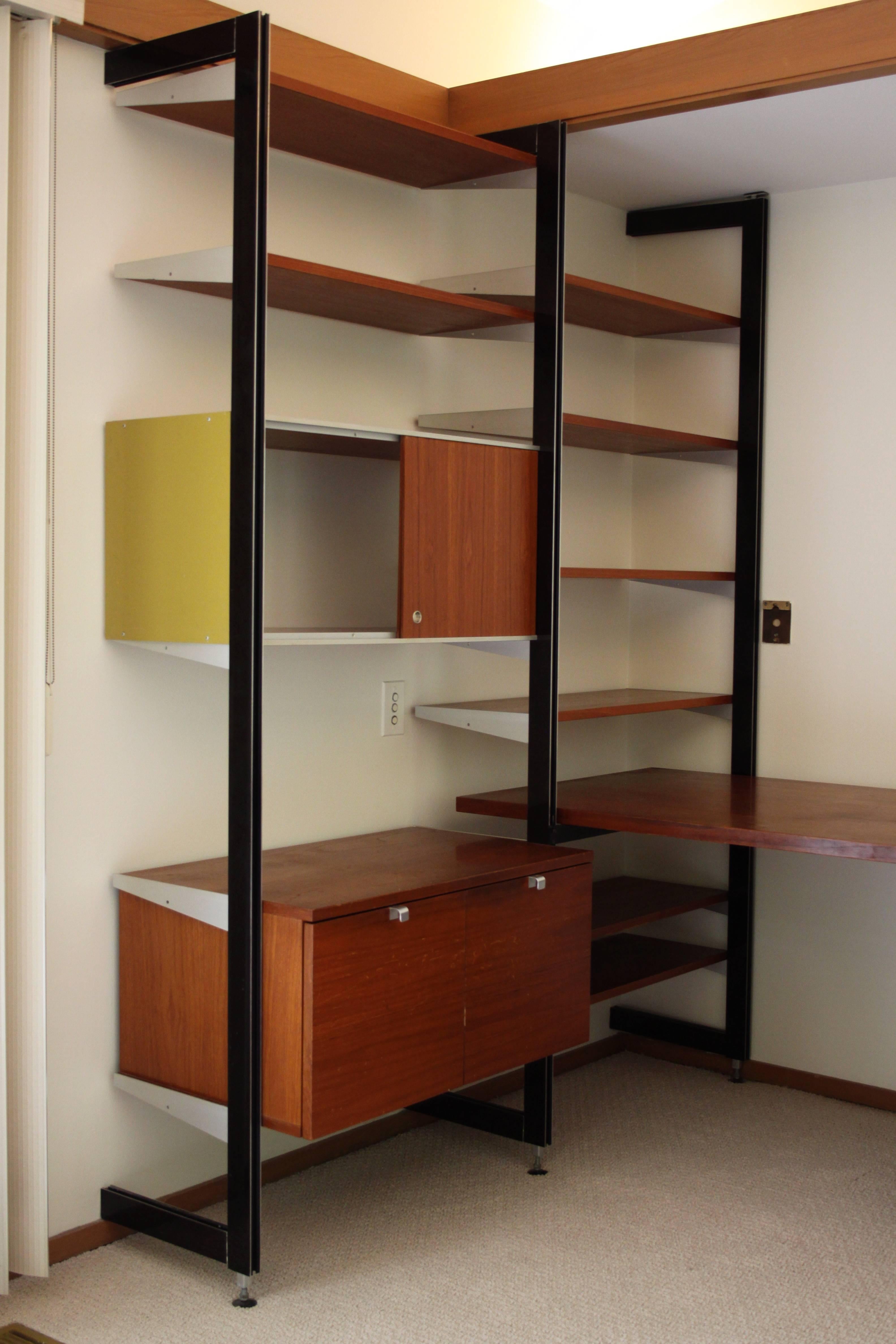George Nelson for Herman Miller comprehensive storage system or CSS desk and wall unit combination. This unit comes with two file drawers, sliding storage area, three drawers that lock (original key), eight shelves and desk top. 
All components are